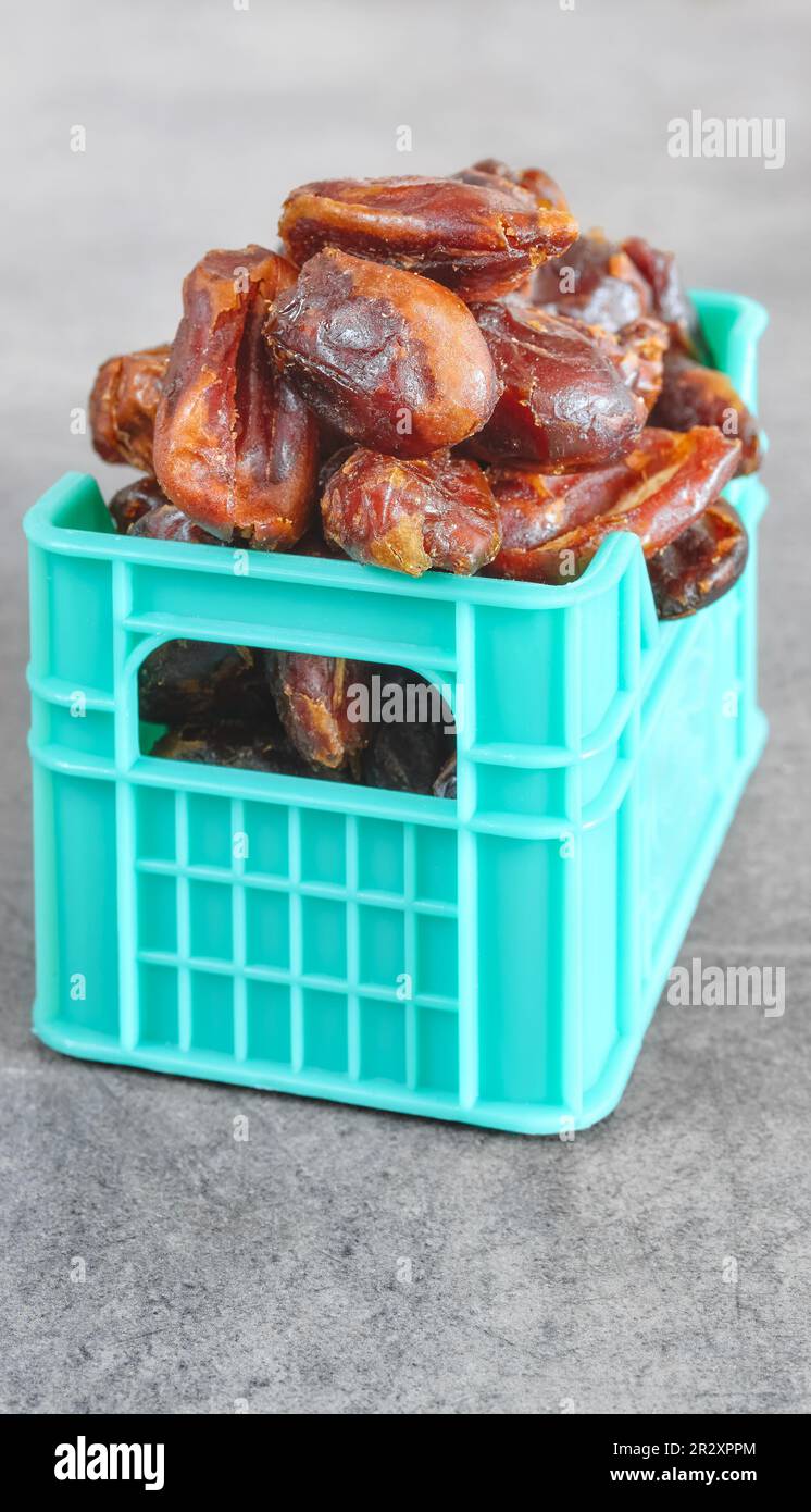 Close up picture of dried organic seedless dates in miniature container