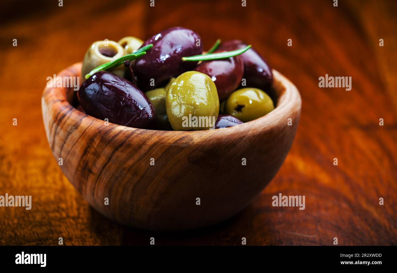Green and black olives in the bowl Stock Photo
