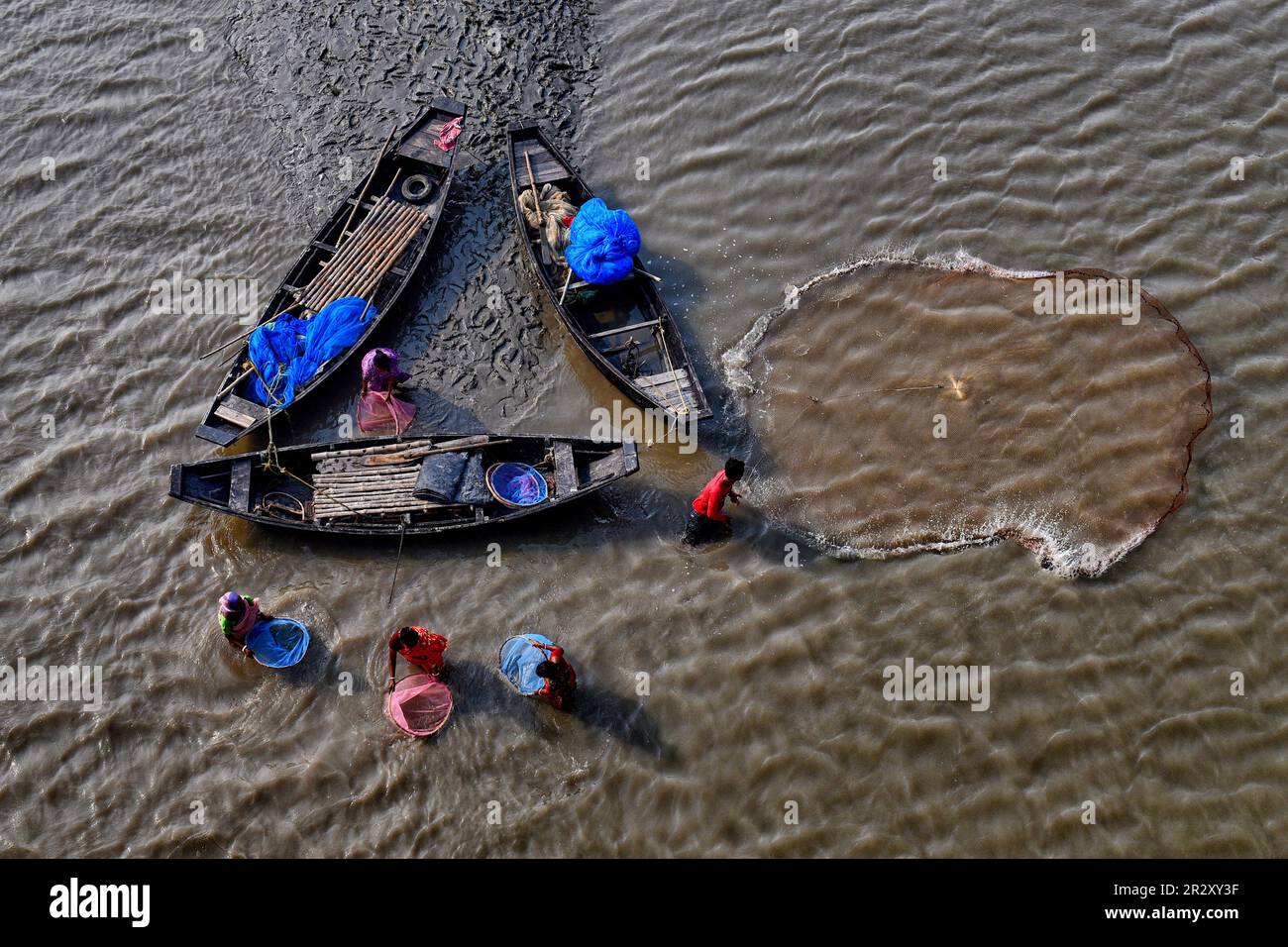 Canning, India. 21st May, 2023. Fishermen seen using colourful nets during fishing on the Matla