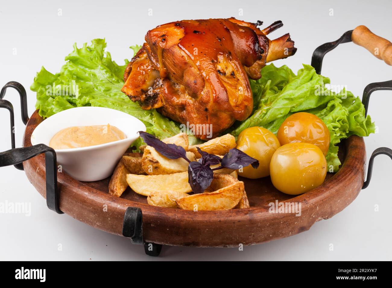 Appetizing roast pork knuckle on cutting board Stock Photo