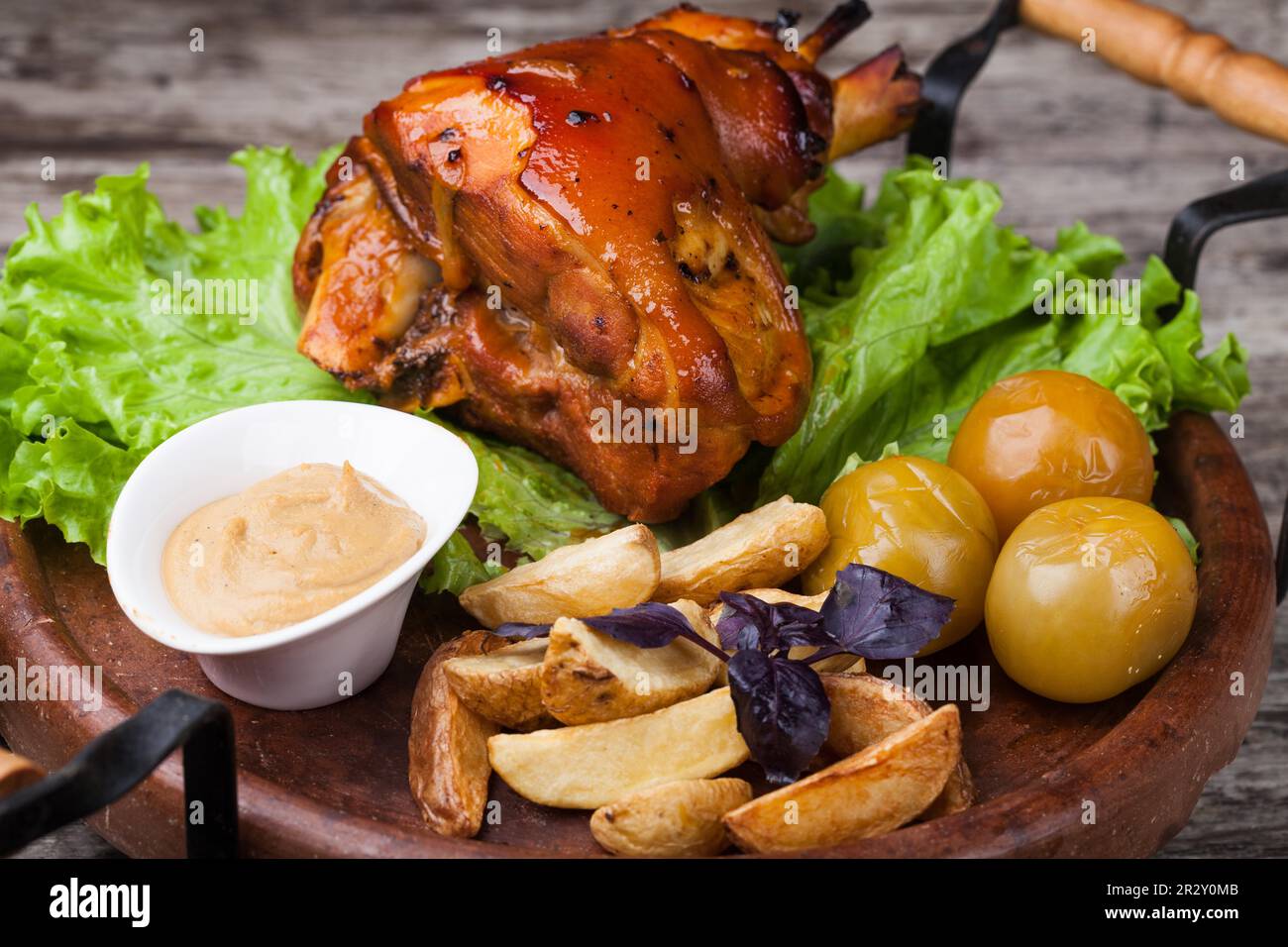 Appetizing roast pork knuckle on cutting board Stock Photo