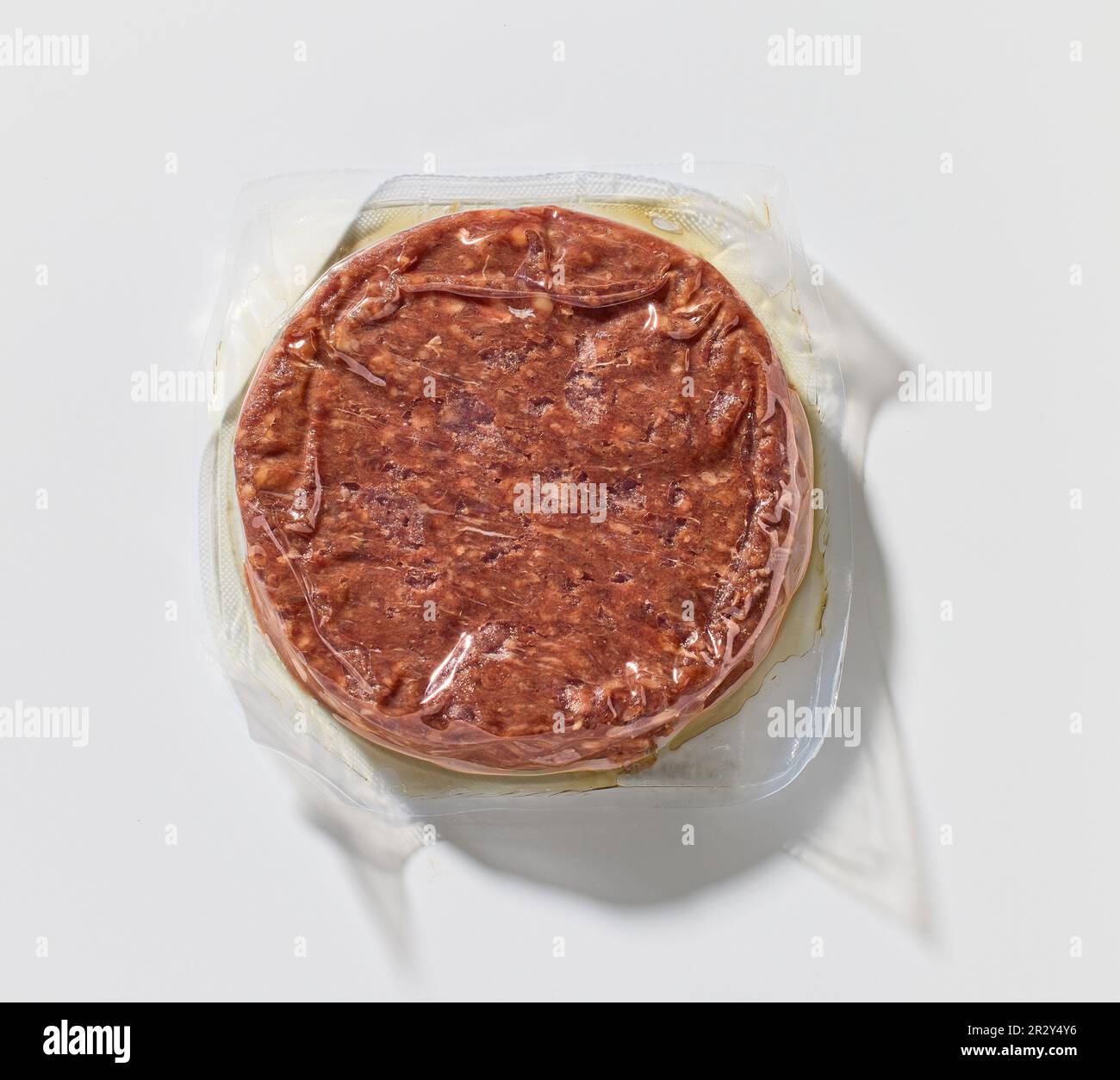 raw beef burger meat for hamburger vacuum packed on white background, top view Stock Photo
