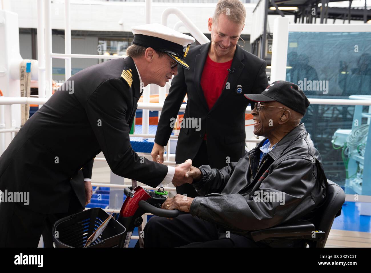 IMAGE DISTRIBUTED FOR PRINCESS CRUISES - Discovery Princess Capt. John  Smith, left, and Princess Cruises President John Padgett, center, greet  retired Lt. Col. James H. Harvey III, a Tuskegee airman, as he