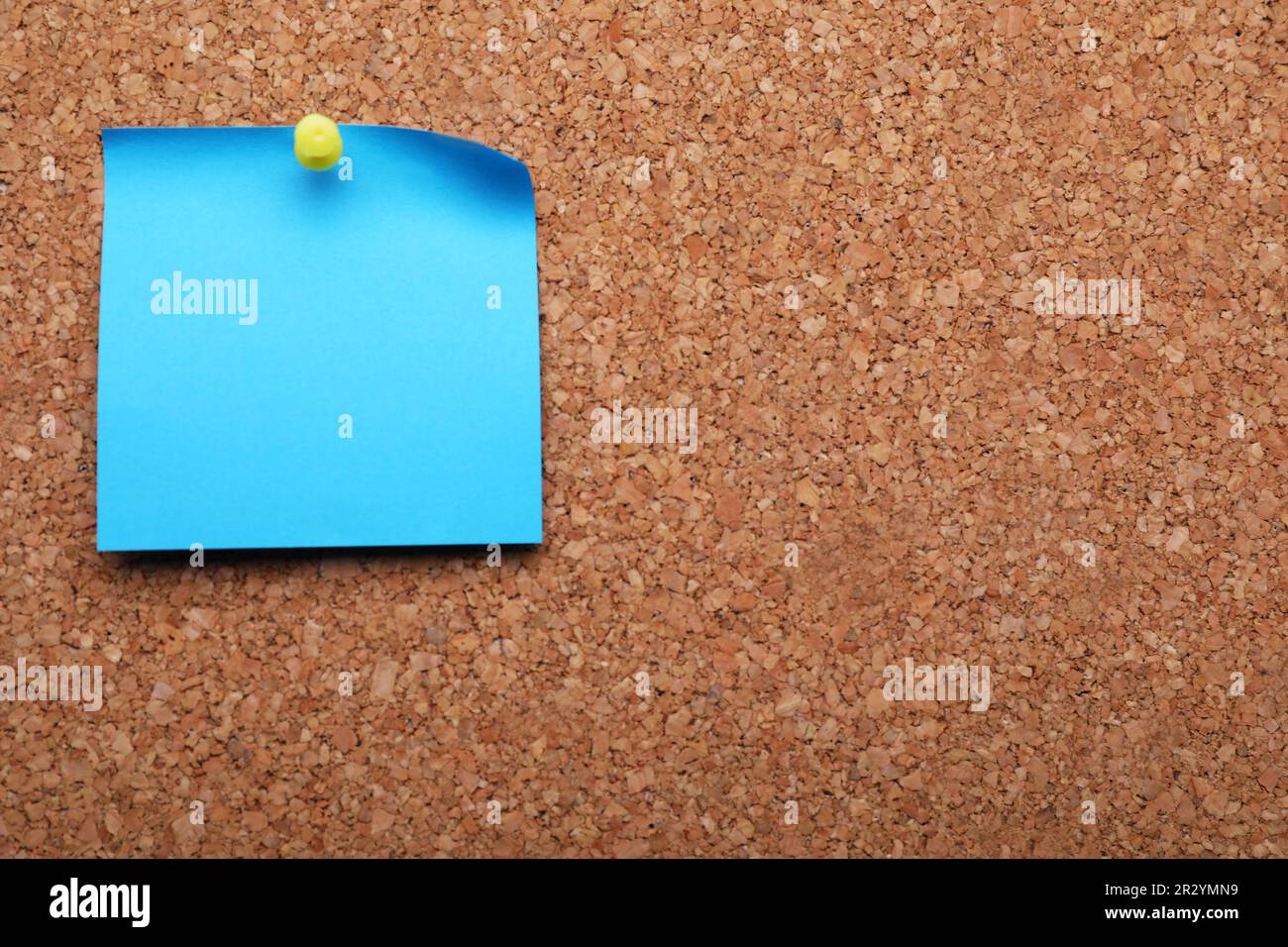 Blank paper note pinned to cork background. Space for text Stock Photo
