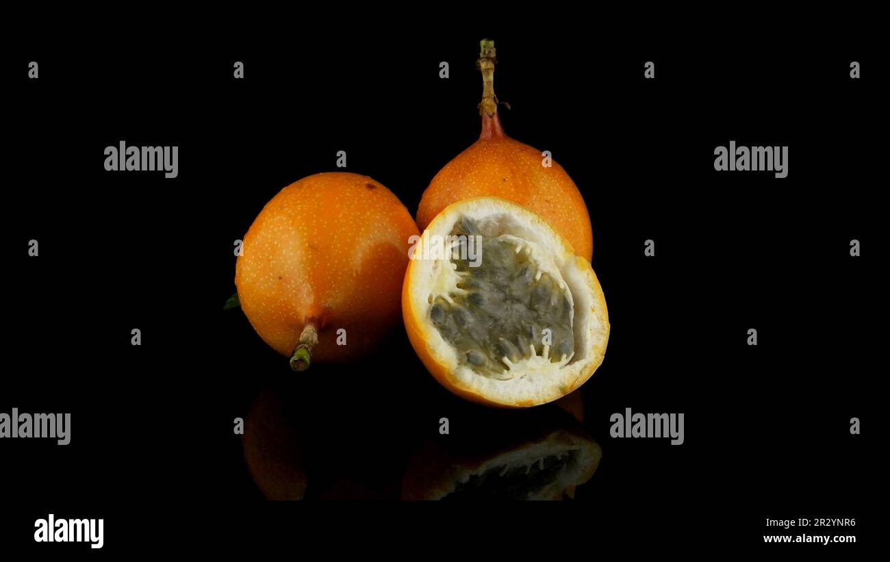 Passion fruit maracuja granadilla on black background Stock Photo - Alamy