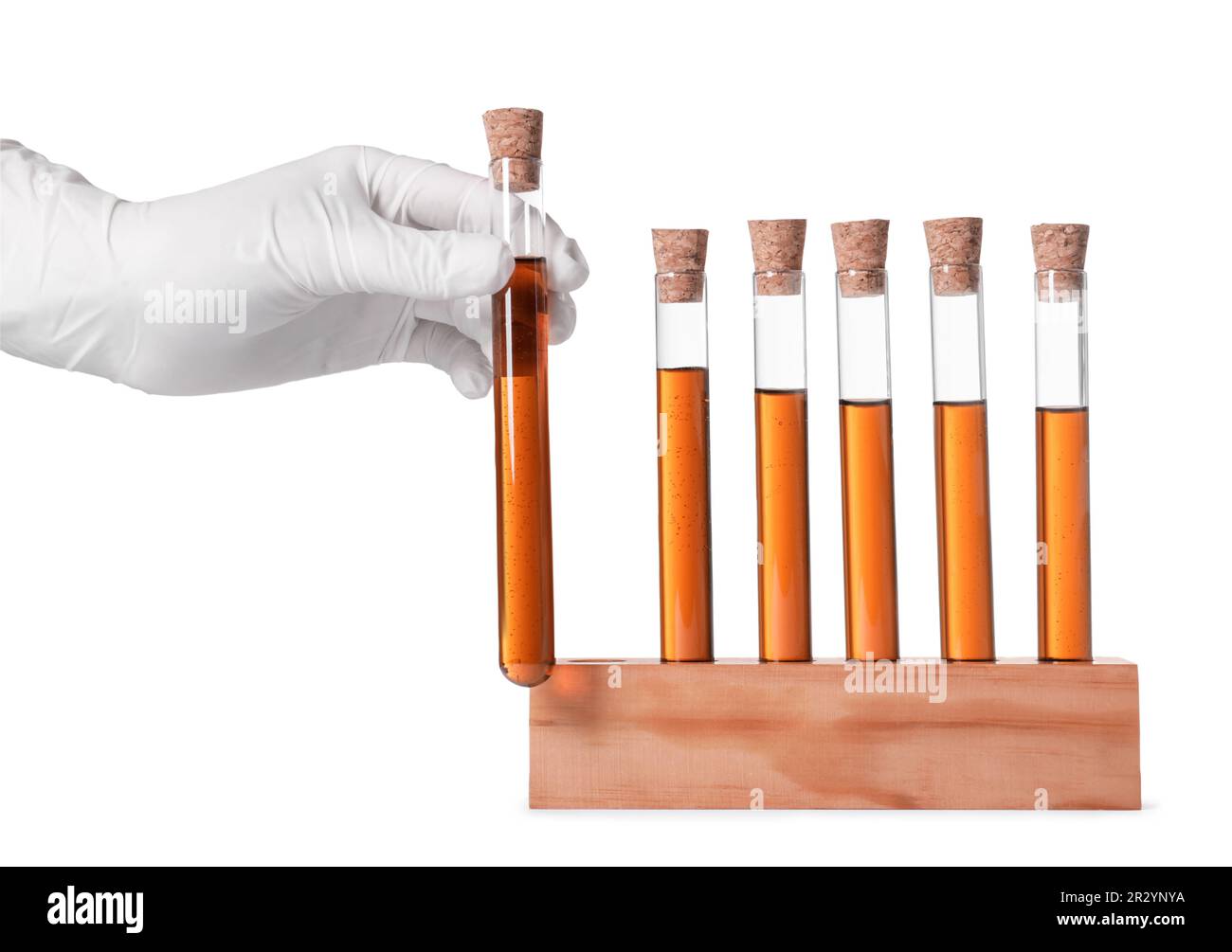 Scientist taking test tube with brown liquid from stand on white