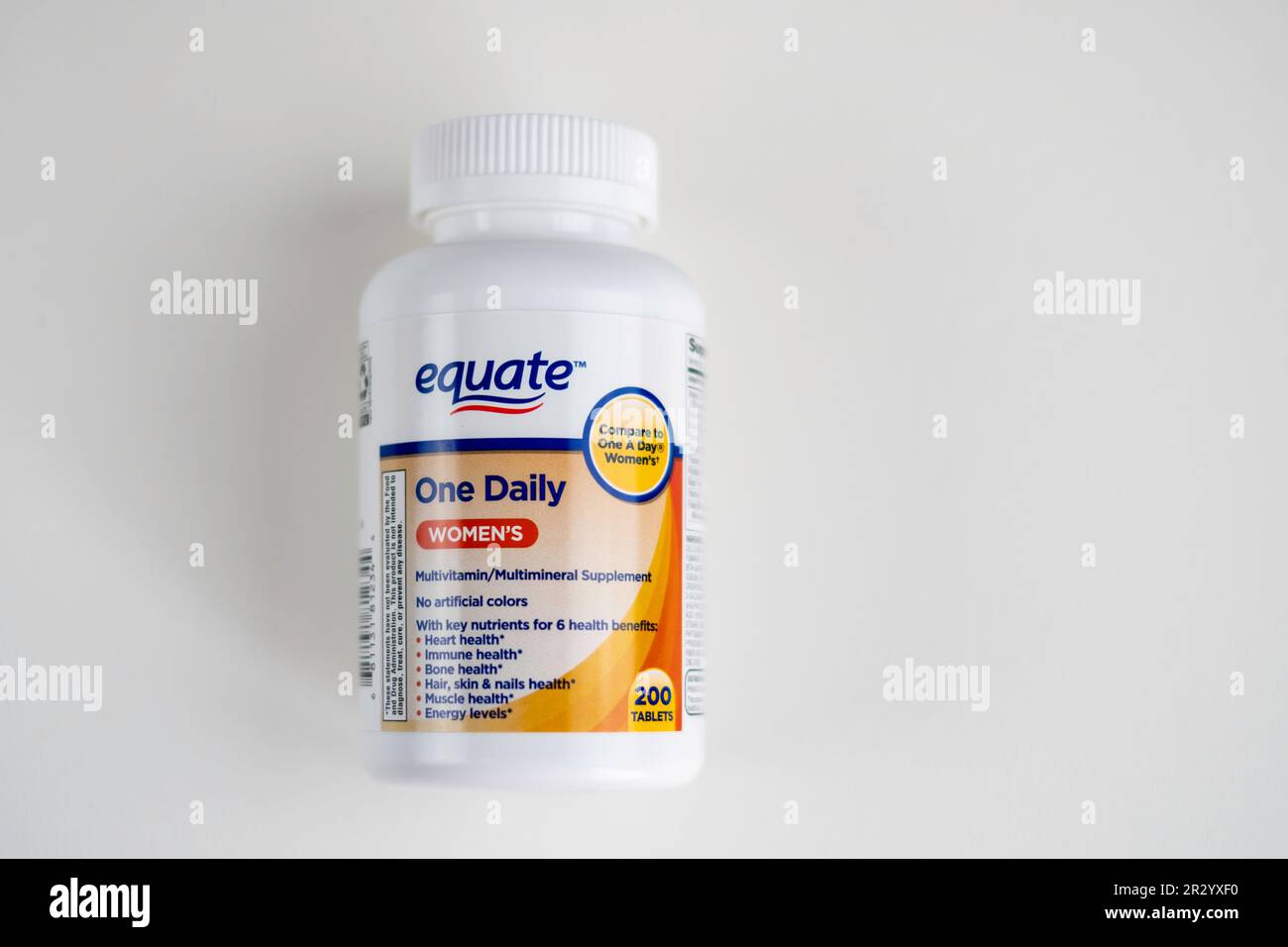 Container of equate brand One Daily Women's vitamins. White backgrounds, cutout. USA. Stock Photo