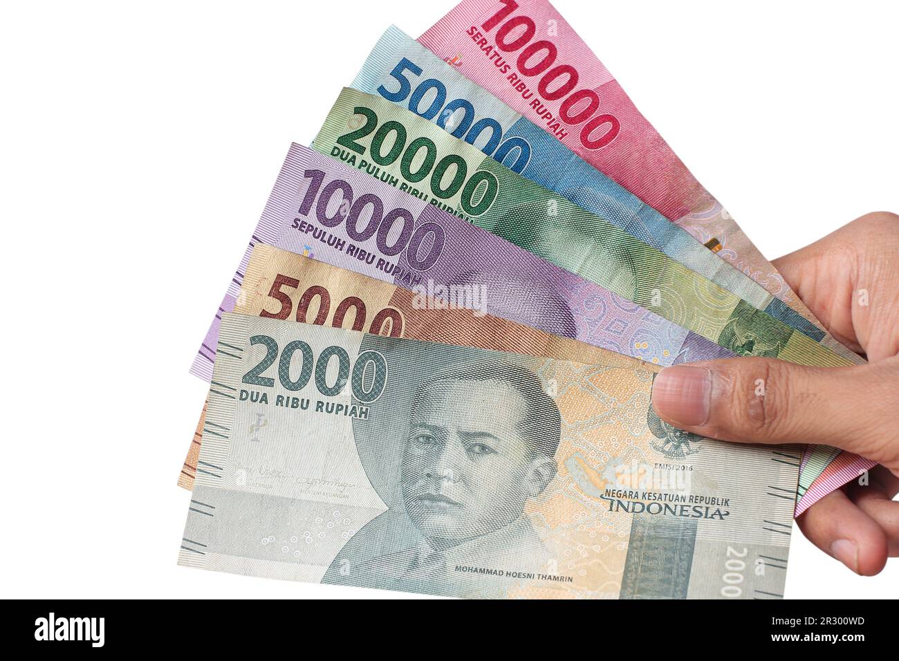 man's hand holding Indonesian rupiah banknotes Stock Photo