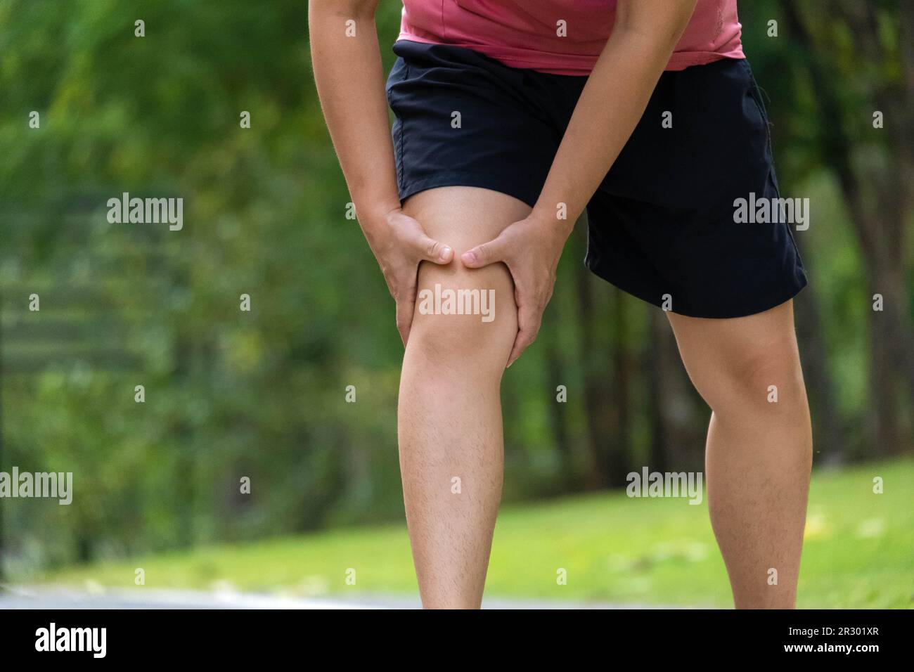 Close Up Of Young Female Athlete Having Knee Pain After Exercise