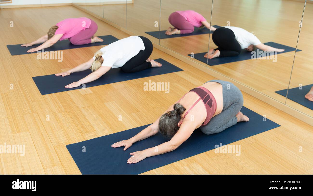 Group yoga class - child pose Stock Photo - Alamy