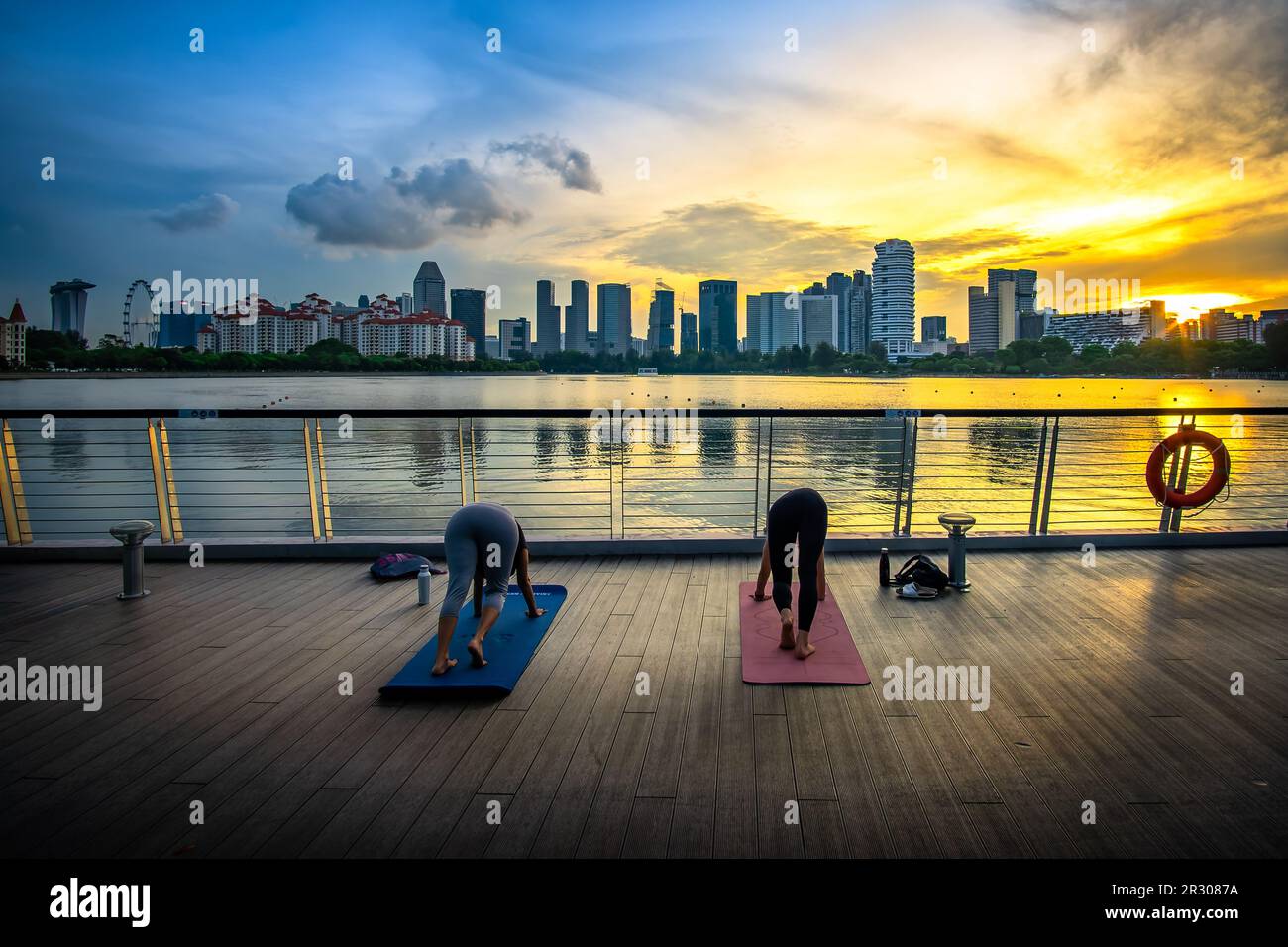 Practicing Yoga at Stadium Riverside Walk of Singapore Sports Hub. It