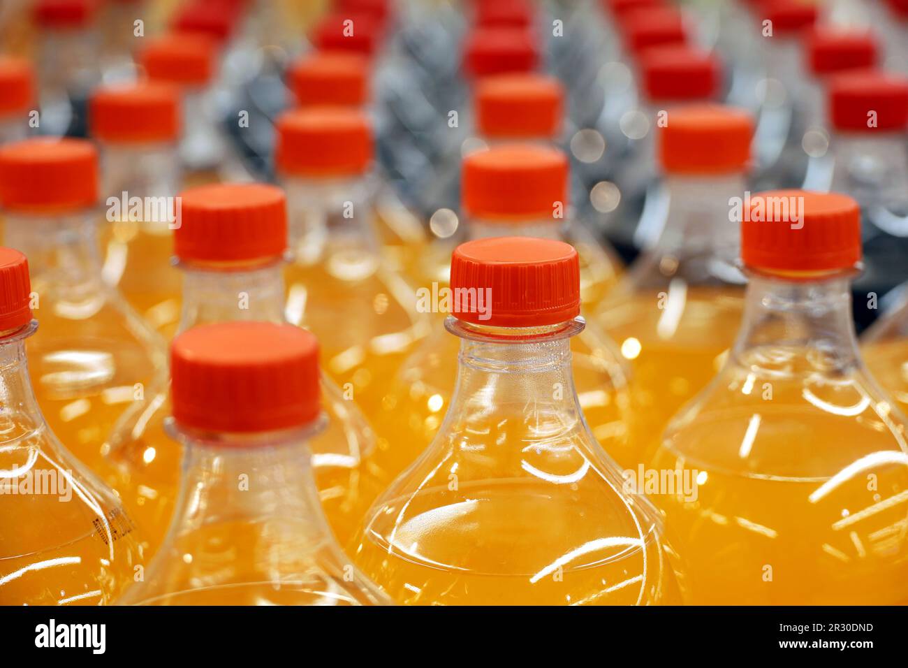 Plastic bottles of sweet soda in a row, selective focus. Soft drinks in a shop Stock Photo