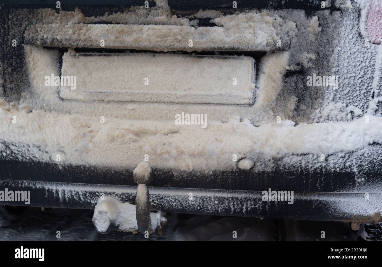 snow and mud covered car license plate. snow and mud covered the