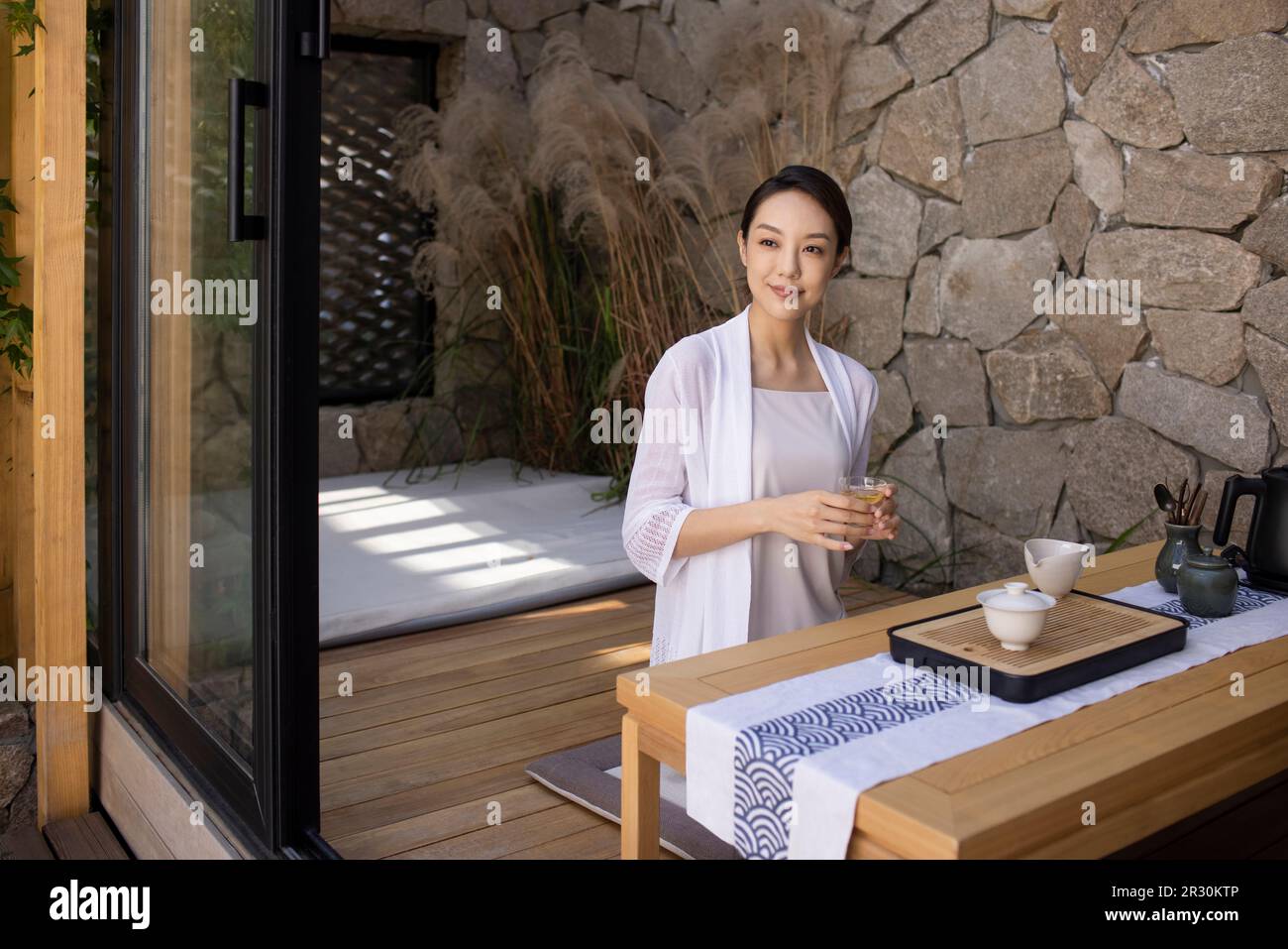 Elegant young Chinese woman drinking tea in tea room Stock Photo - Alamy