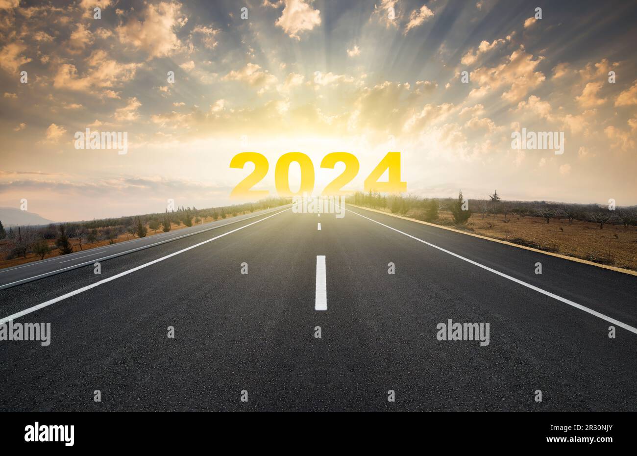 Start the year 2024. Happy New Year greeting card. Year 2024 lettering on horizon with empty asphalt road Stock Photo