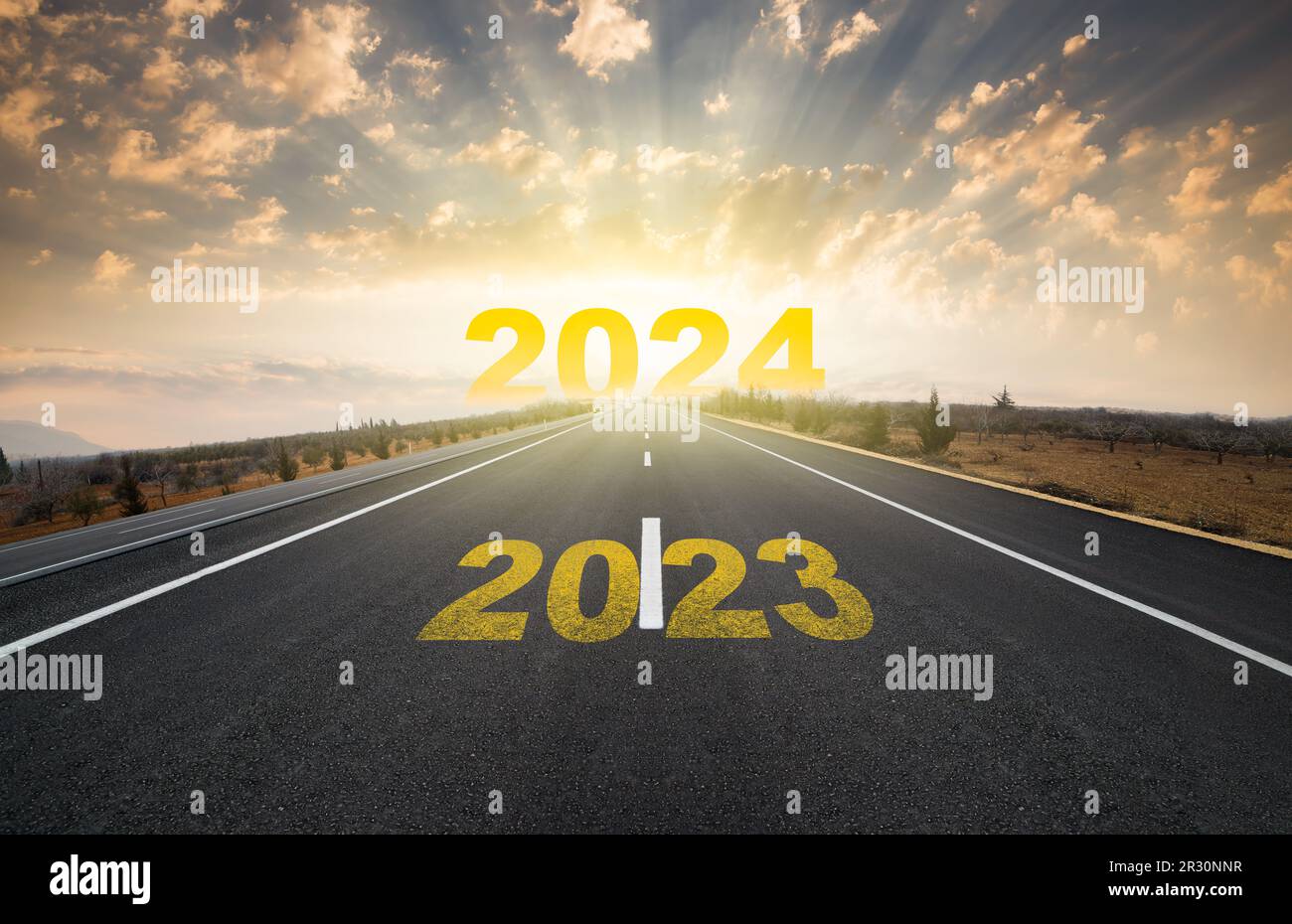 Change of calendar. 2024 anniversary. Transition from 2023 to the new year. Golden sunrise on asphalt empty road. New year concept Stock Photo
