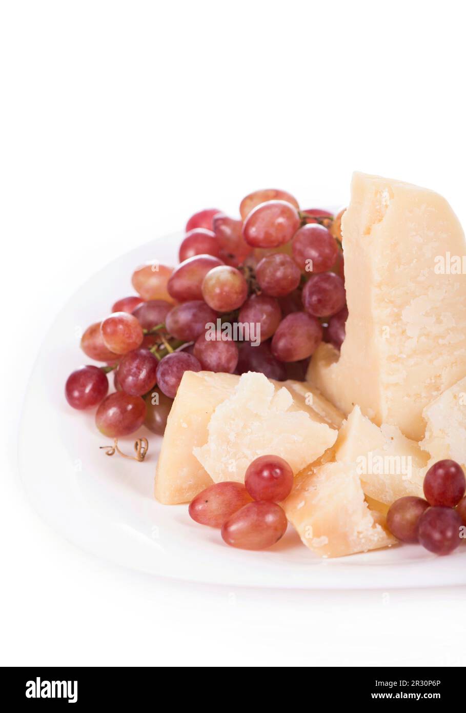 Parmesan cheese and grapes isolated on a white backgroun. View from above Stock Photo
