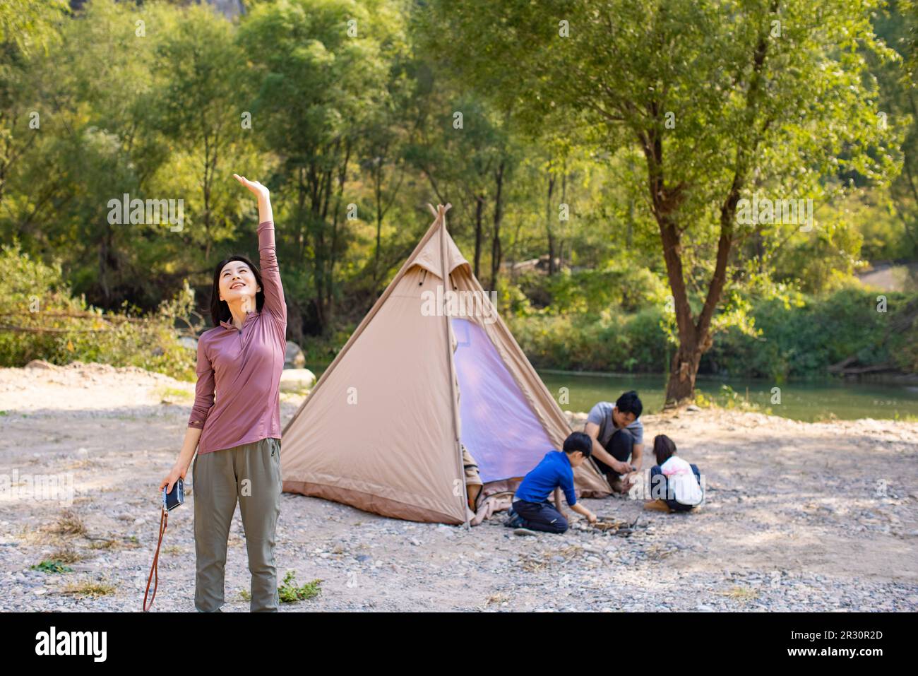 Happy young Chinese family camping outdoors Stock Photo Alamy