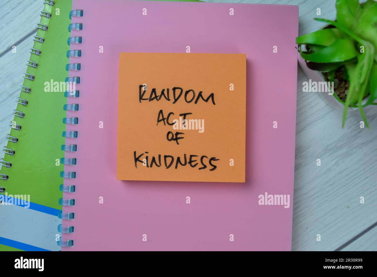 Concept of Random Act of Kindness write on sticky notes isolated on Wooden Table. Stock Photo