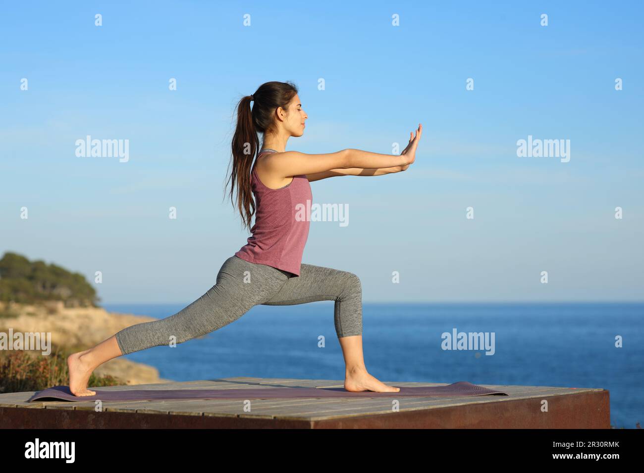 Full body profile of a woman doing tai chi exercise on the beach Stock ...