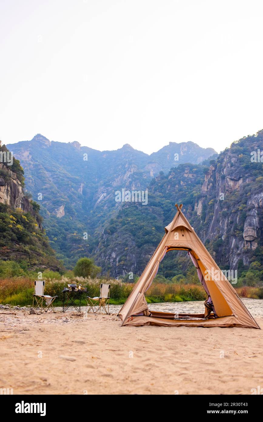 Camping tent by the river Stock Photo - Alamy