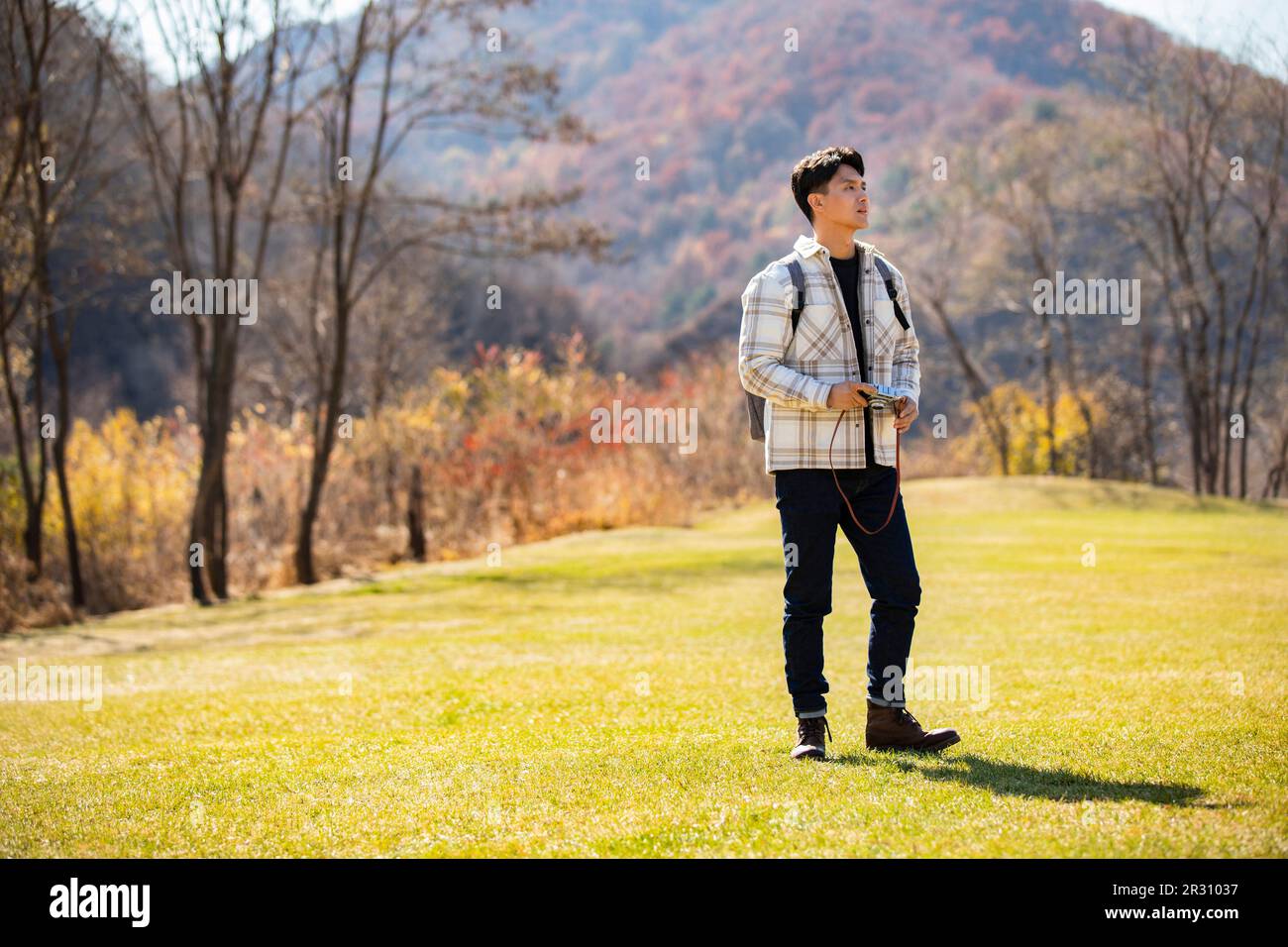 Young man taking photos outdoors Stock Photo