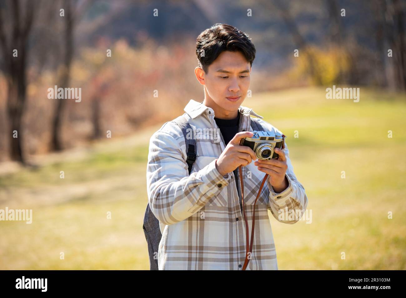 Young man taking photos outdoors Stock Photo