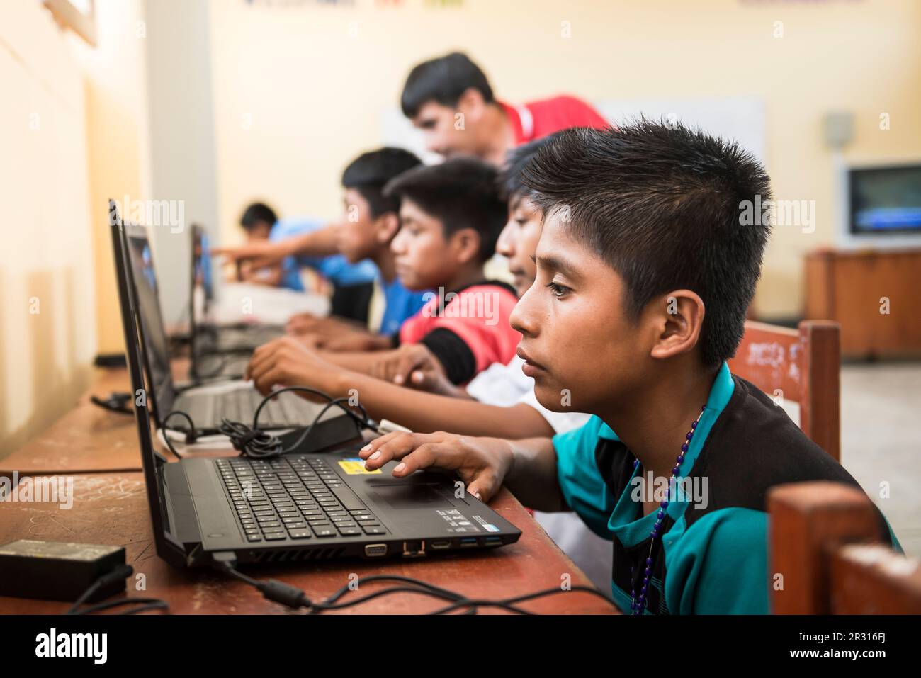 Peruvian children learning English using computers in a classroom Stock ...