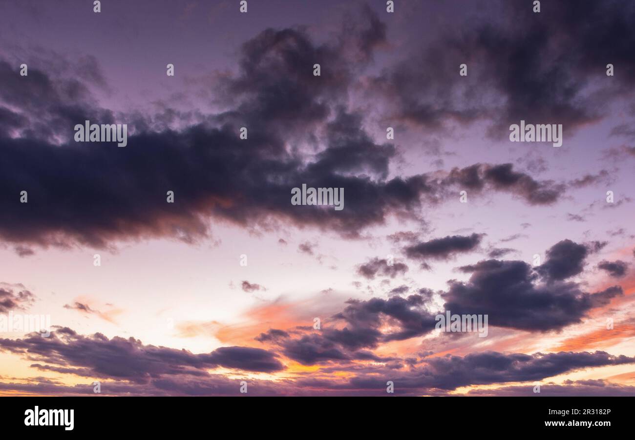 dramatic cloudscape at dusk. sky in colorful evening light. changing weather forecast Stock Photo