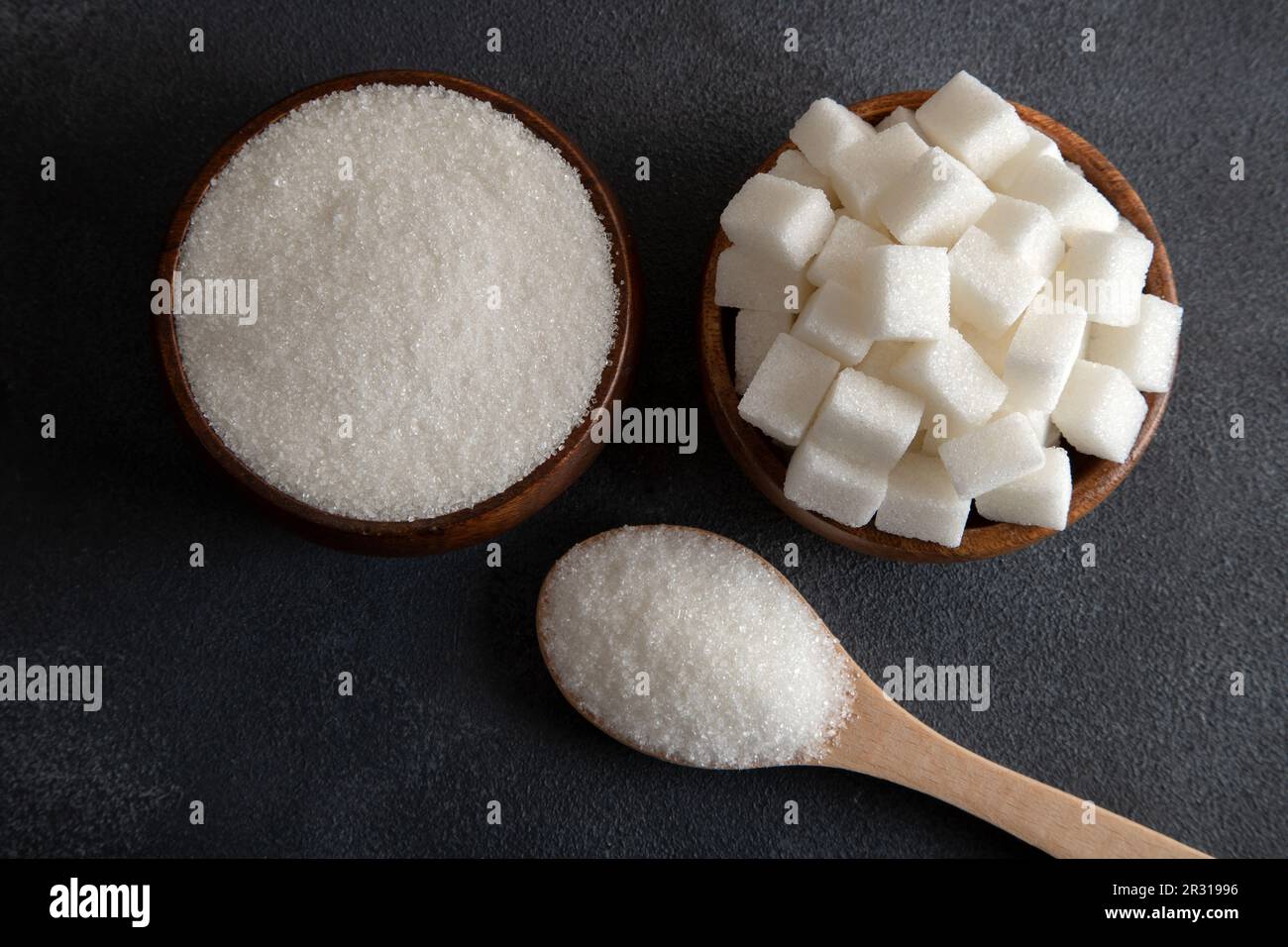 Cube sugar and granulated sugar on black background,closeup Stock Photo ...