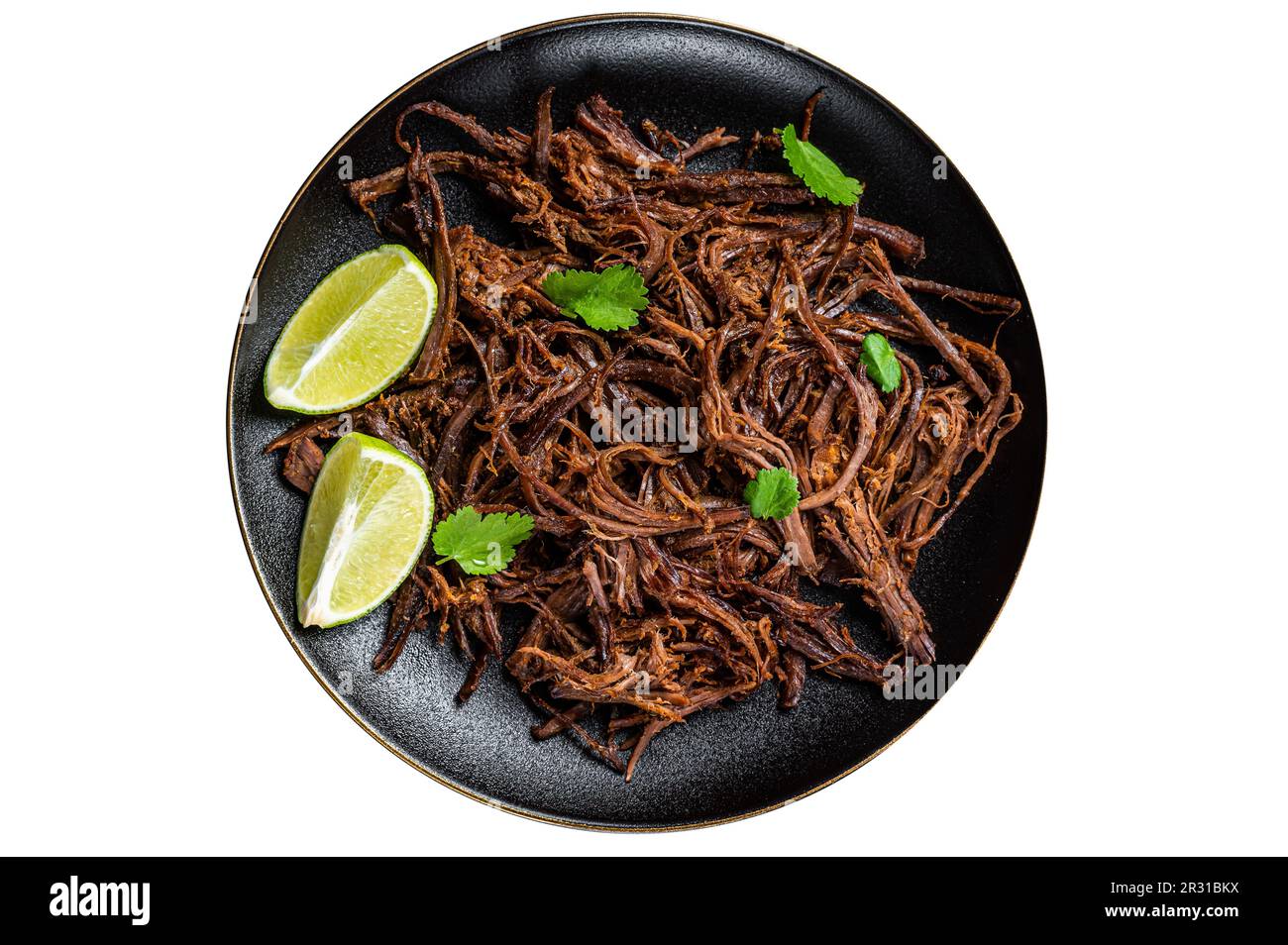 Carnitas in a plate with celery and lime wedges. Isolated on white background Stock Photo
