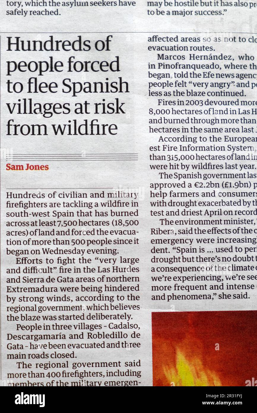 'Hundreds of people forced to flee Spanish villages at risk from wildfire' Guardian newspaper headline climate crisis article 20 May 2023 London UK Stock Photo