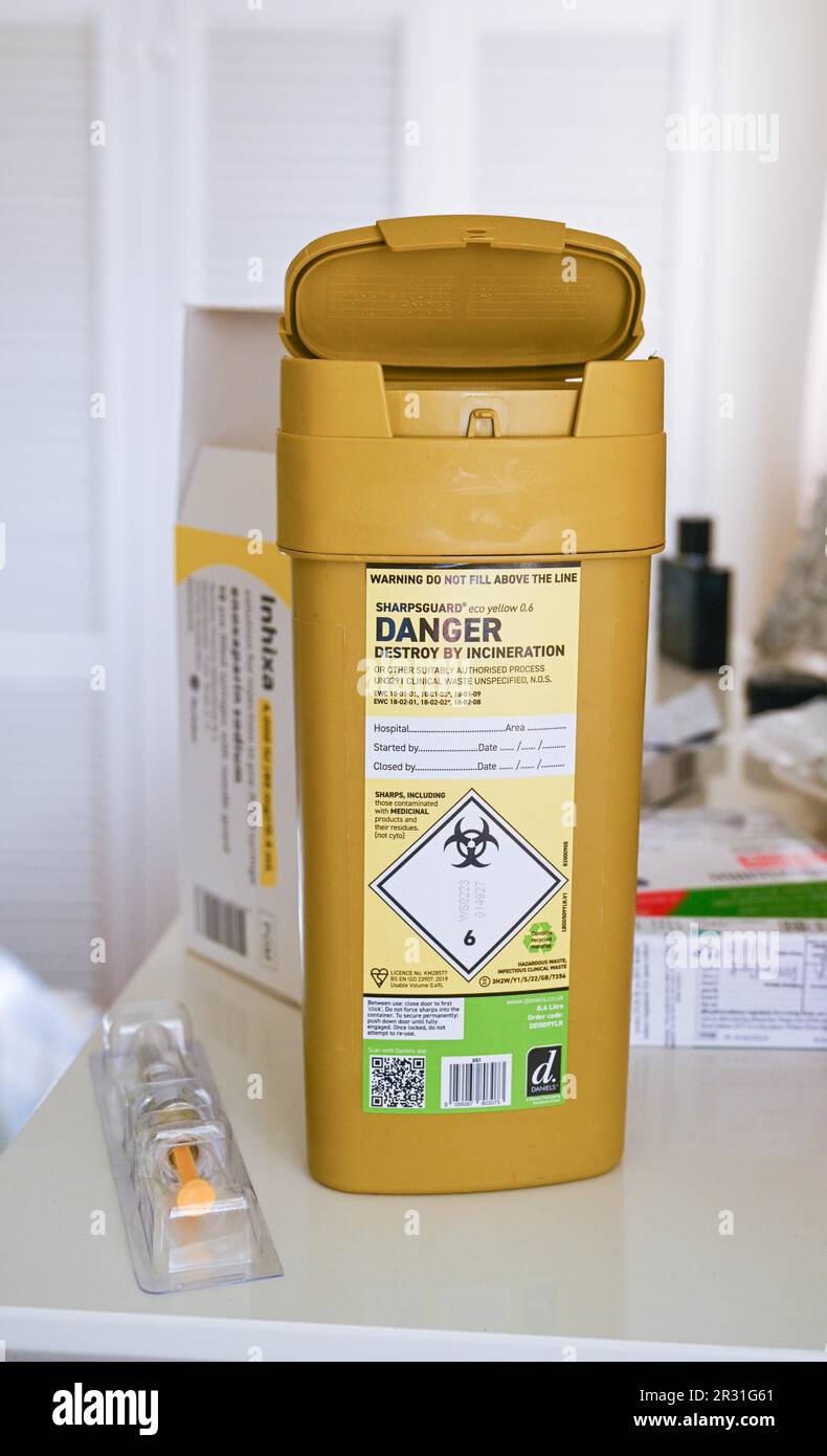 Sharpsguard disposal waste unit or sharps bin for getting rid of used needles safely Stock Photo