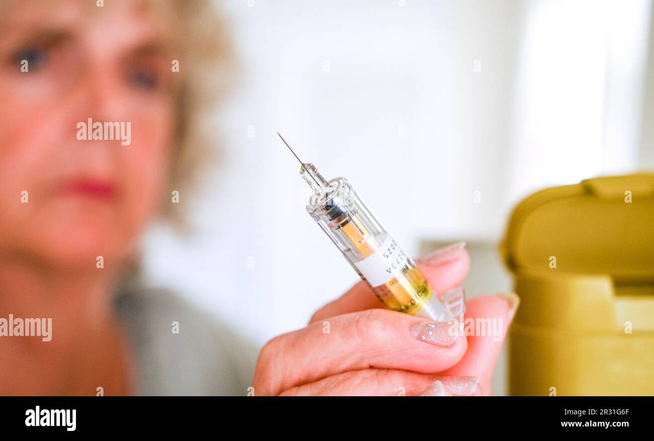 Woman about to use an injection needle for health use at home Stock Photo