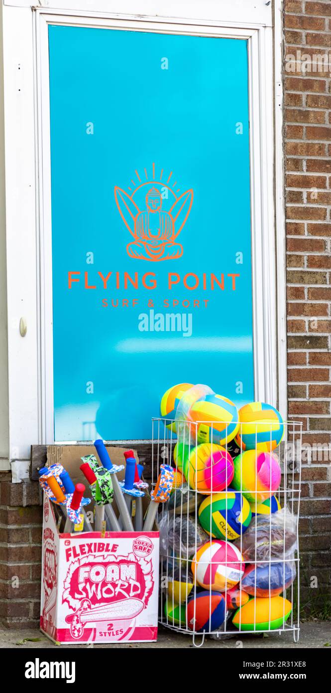 Pool toys on display on the sidewalk at Flying Point Surf Shop, Sag