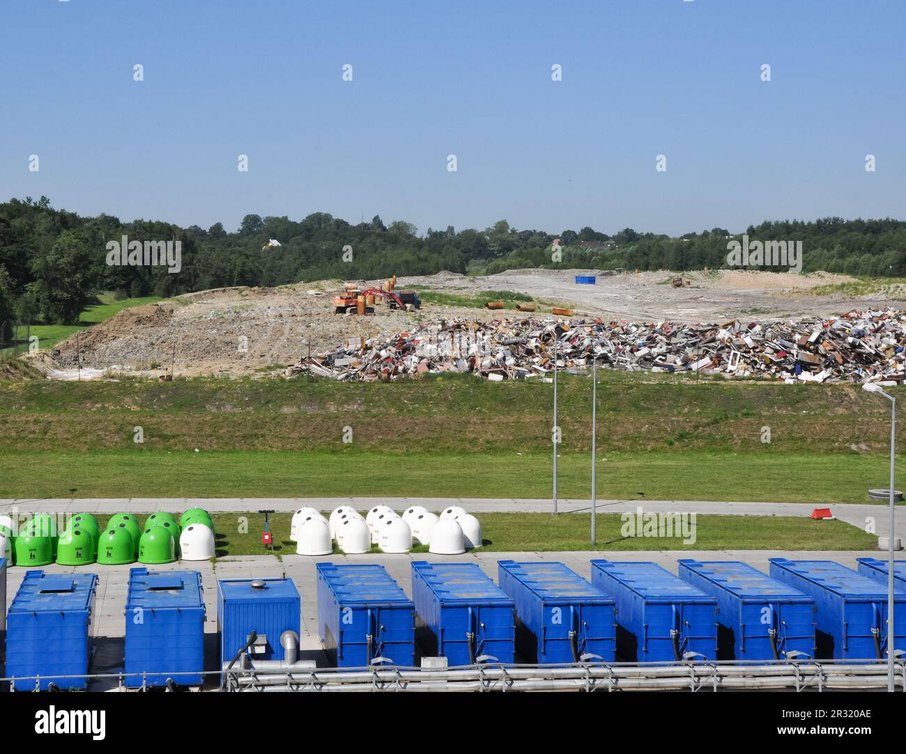 Nature against trash, flowers in the foreground in a waste recycling