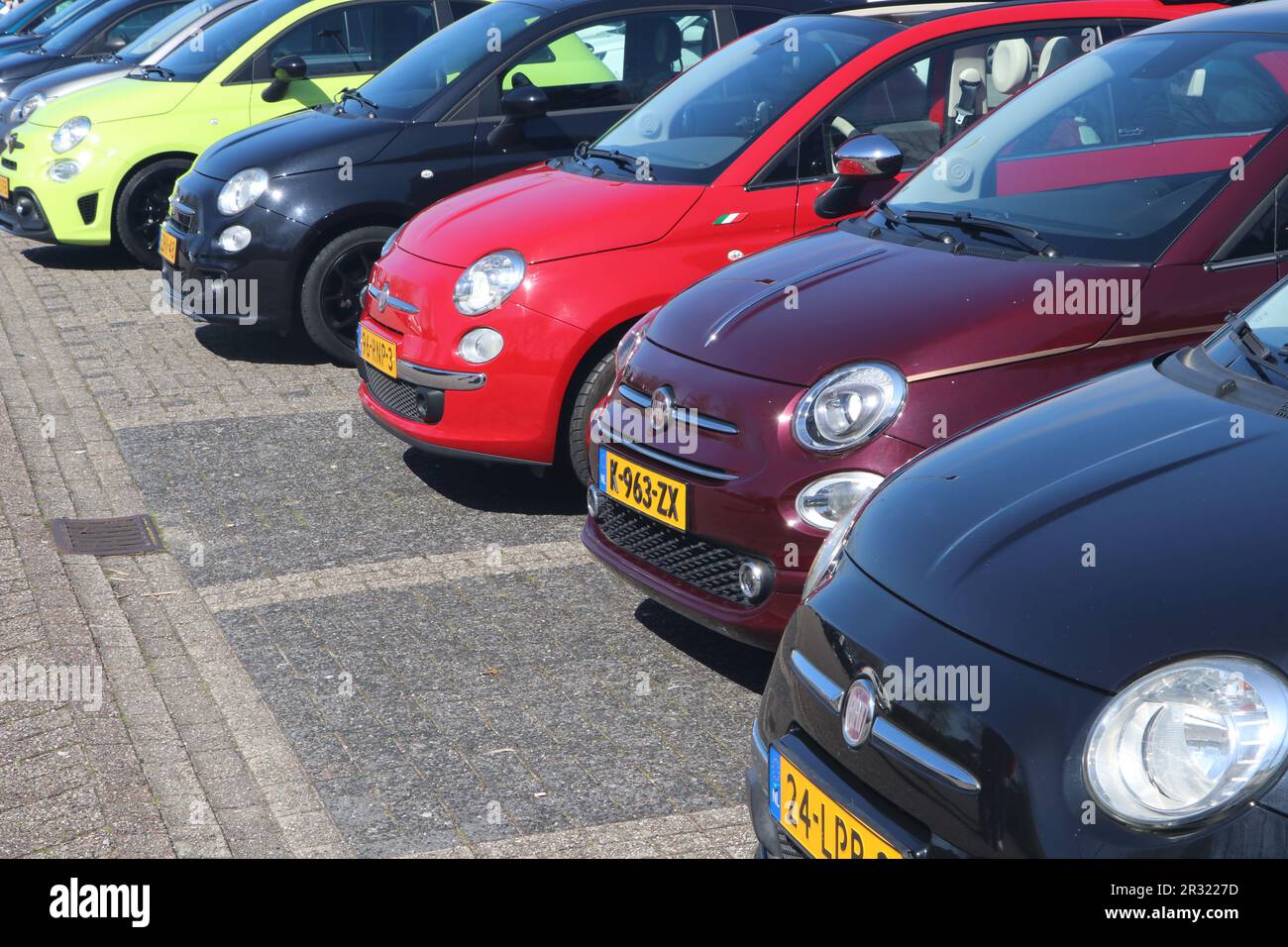 row of Fiat 500 cars on parking lot in Hoorn, the Netherlands - April 30 2023 Stock Photo