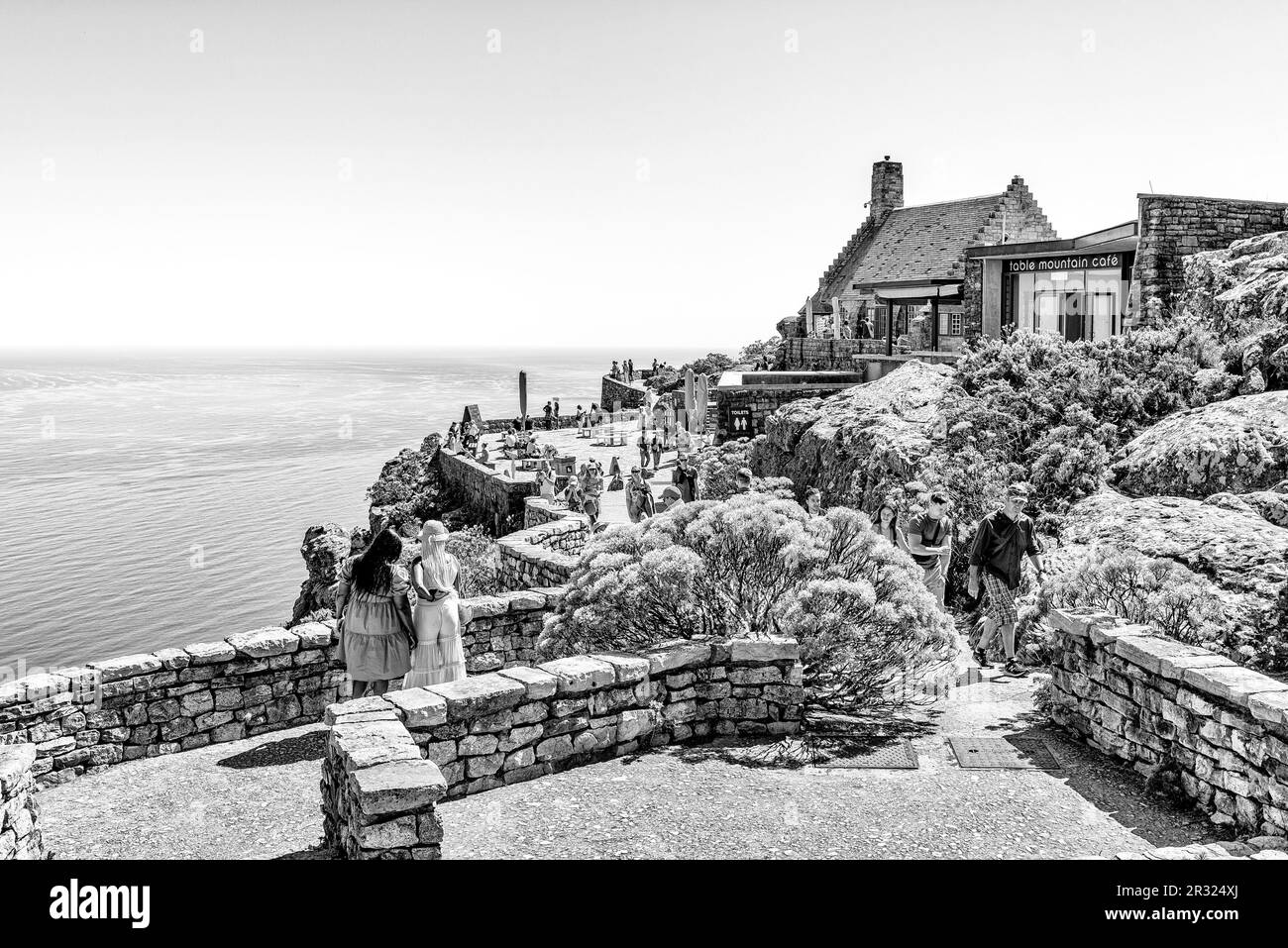 Cape Town, South Africa - Sep 14, 2022: Tourists are visible at a viewpoint on Table Mountain in Cape Town. Buildings and the Atlantic Ocean are visib Stock Photo