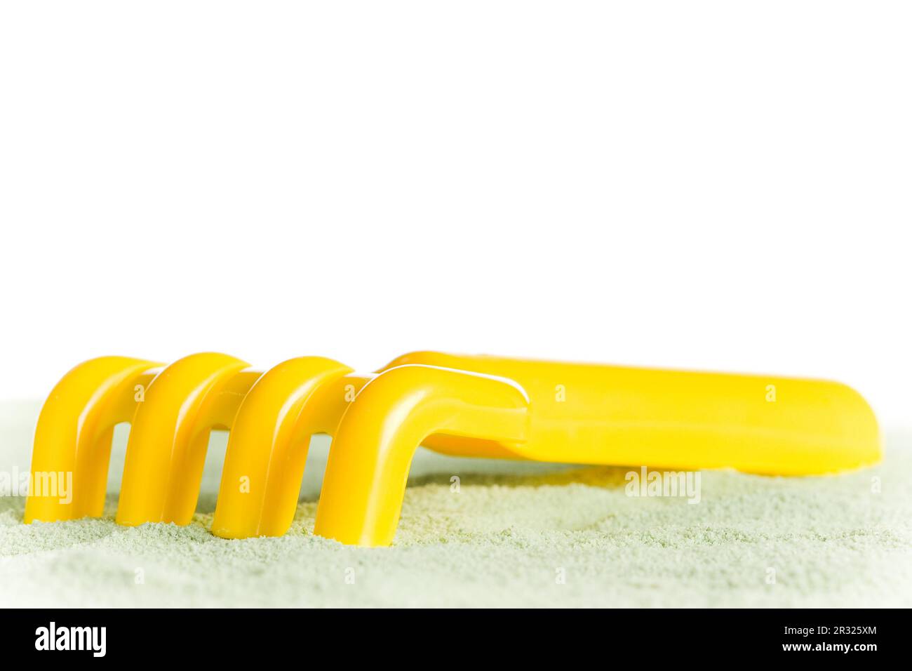 Yellow toy rake Stock Photo - Alamy