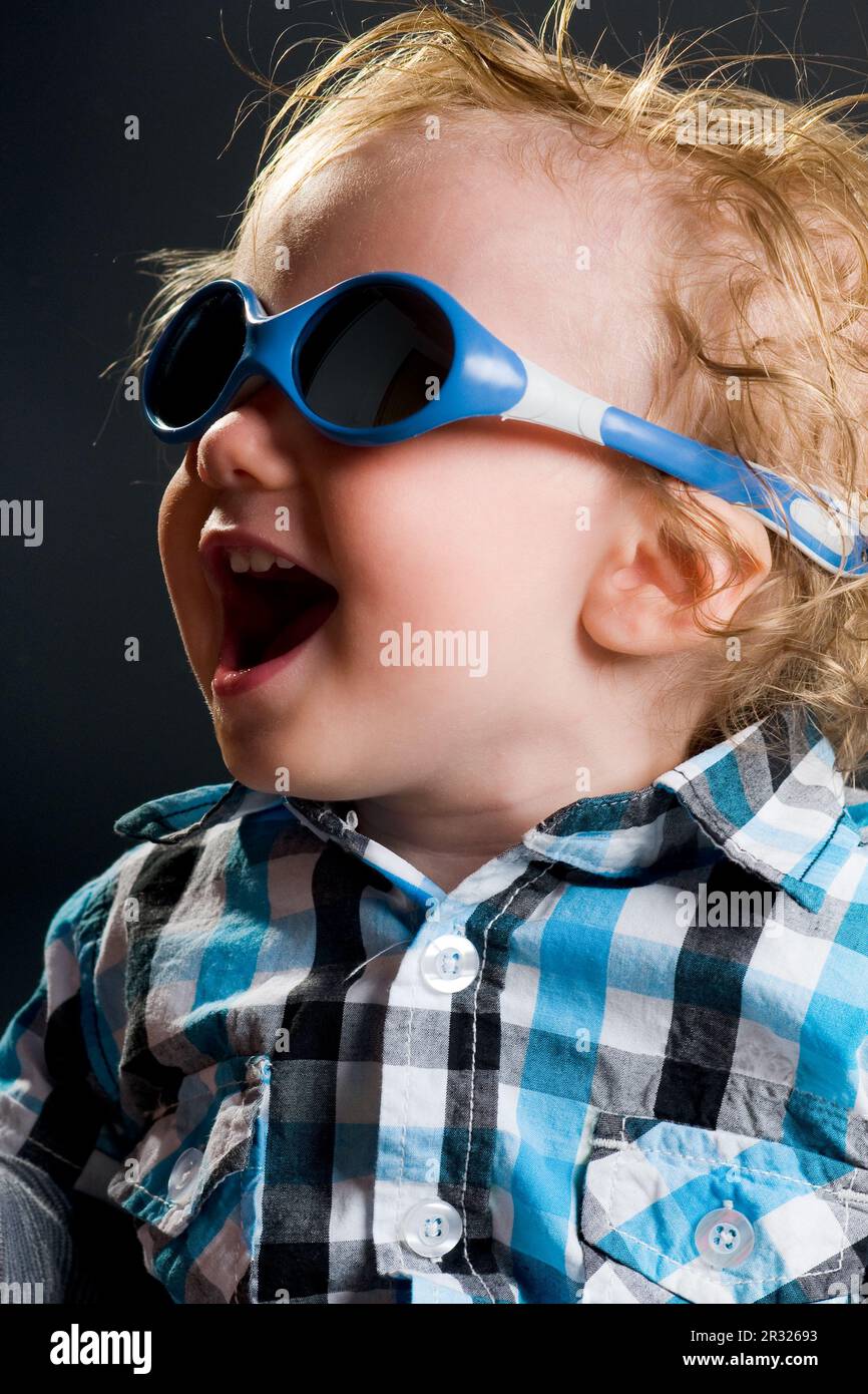 glücklicher junge mit hemd und sonnenbrille lacht Stock Photo