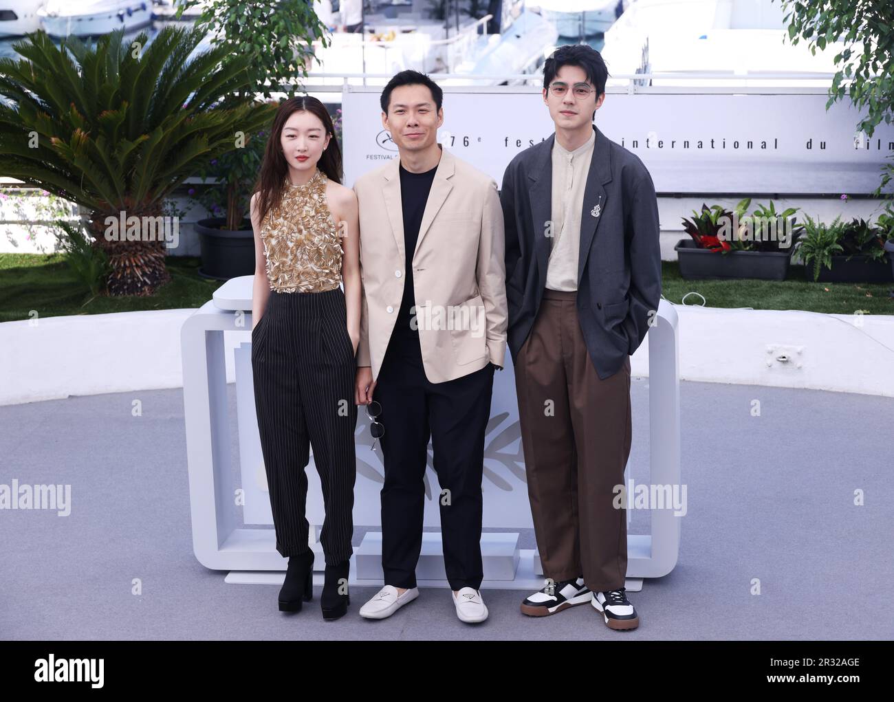 Cannes, France. 22nd May, 2023. Chinese actor Liu Haoran (R), Singaporean director Anthony Chen (C) and Chinese actress Zhou Dongyu pose during a photocall for the film 'Ran Dong' (The Breaking Ice) at the 76th edition of the Cannes Film Festival in Cannes, southern France, on May 22, 2023. Credit: Li Bohan/Xinhua/Alamy Live News Stock Photo