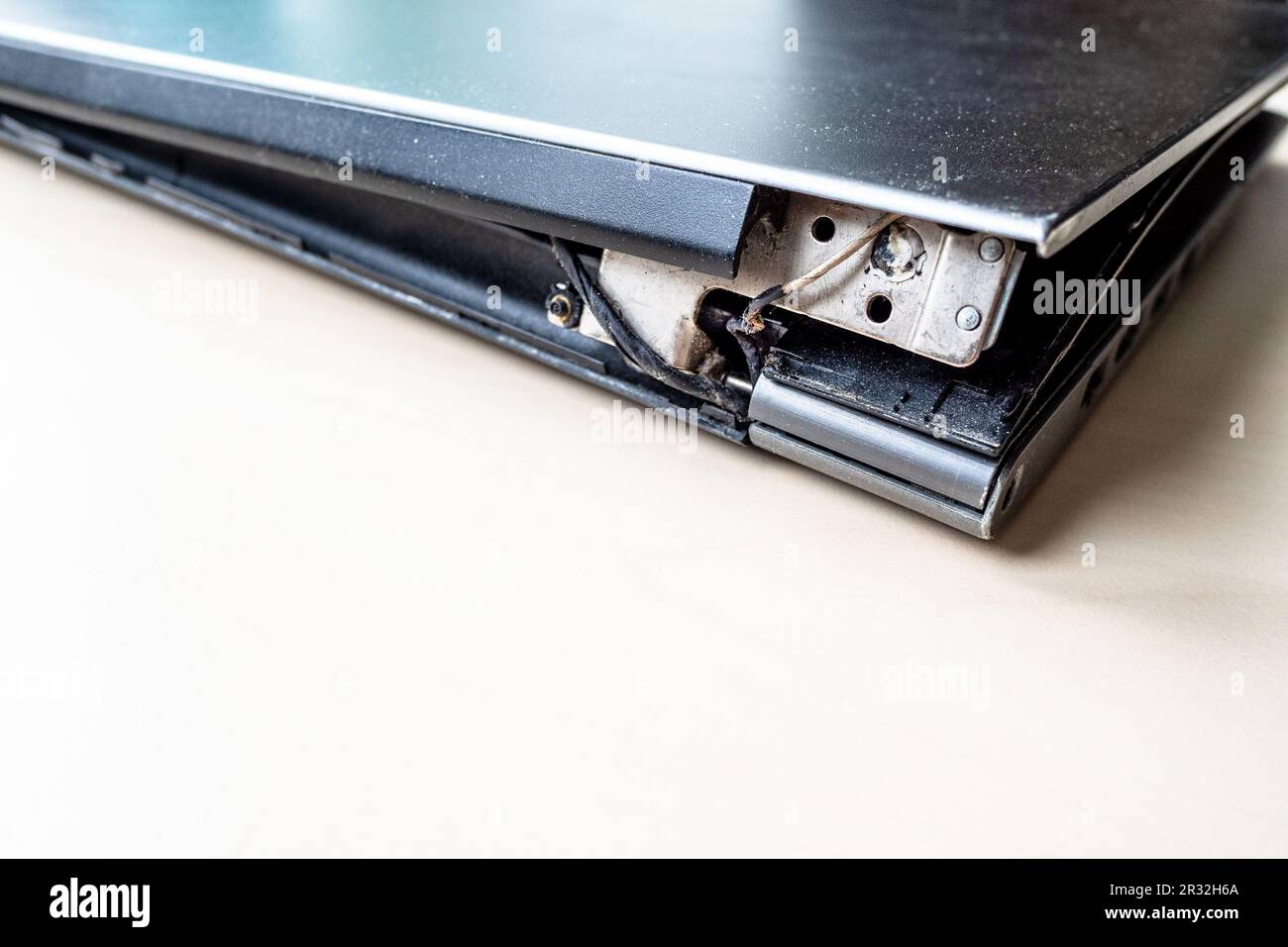 burnt electrical power wire and broken fixation old laptop on the table ...