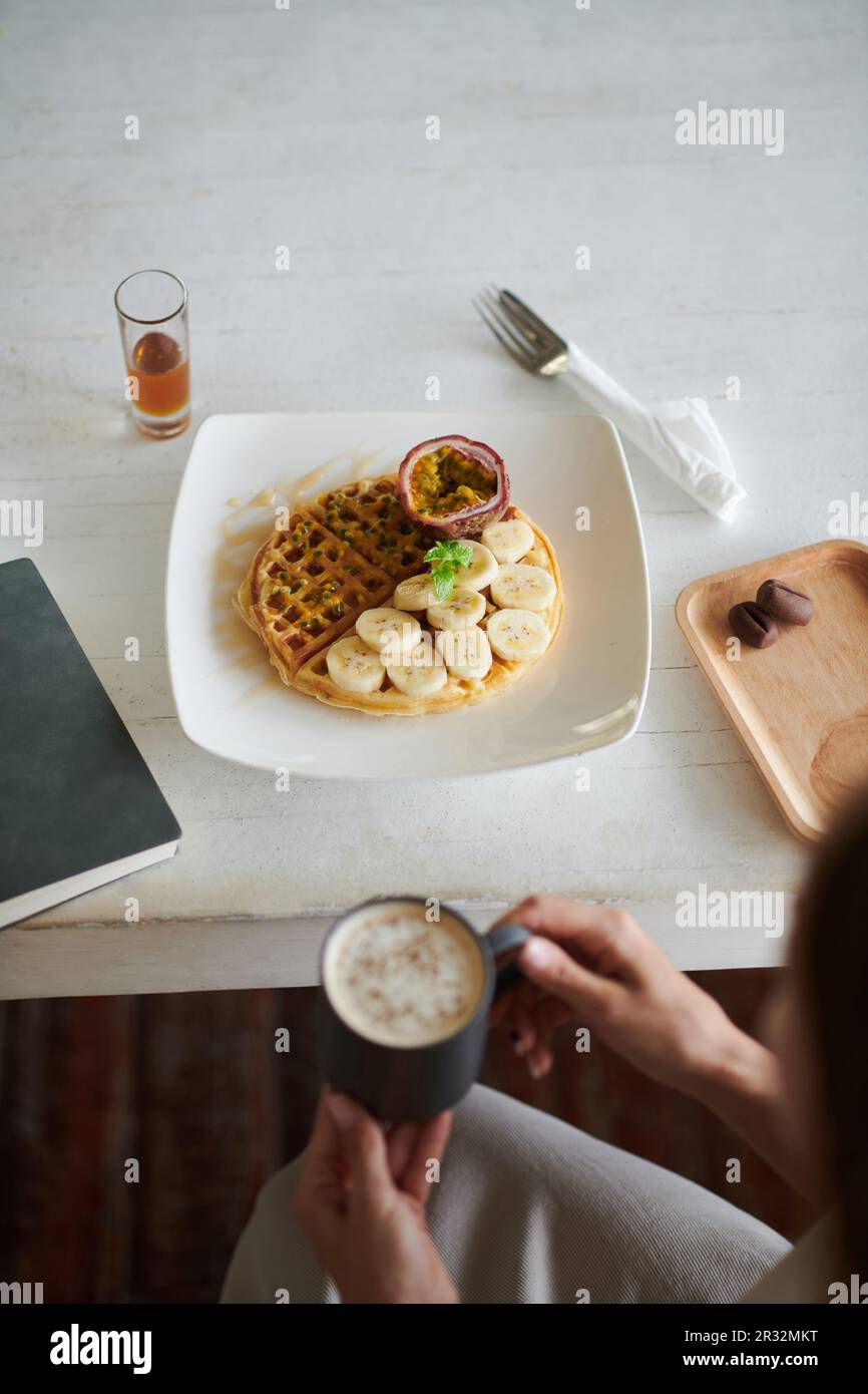 Waffles with sliced bananas and passion fruits for breakfast Stock ...