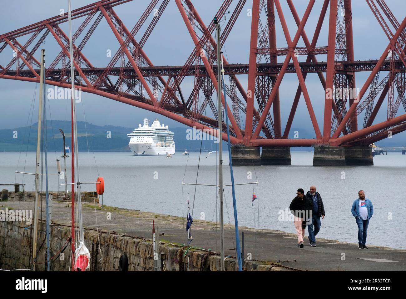 South Queensferry, Scotland, UK. 22nd May 2023. Jewel of the Seas, a 90,000 tonne, 965 feet, mega cruise liner with 12 passenger decks and equiped with its own waterpark, theatre, casino, elevators and rock climbing wall, arrived in the Forth estuary this morning for a rare stopover. Berthed beside the Forth bridge allowing the sense of scale to be appreciated. Credit: Craig Brown/Alamy Live News Stock Photo
