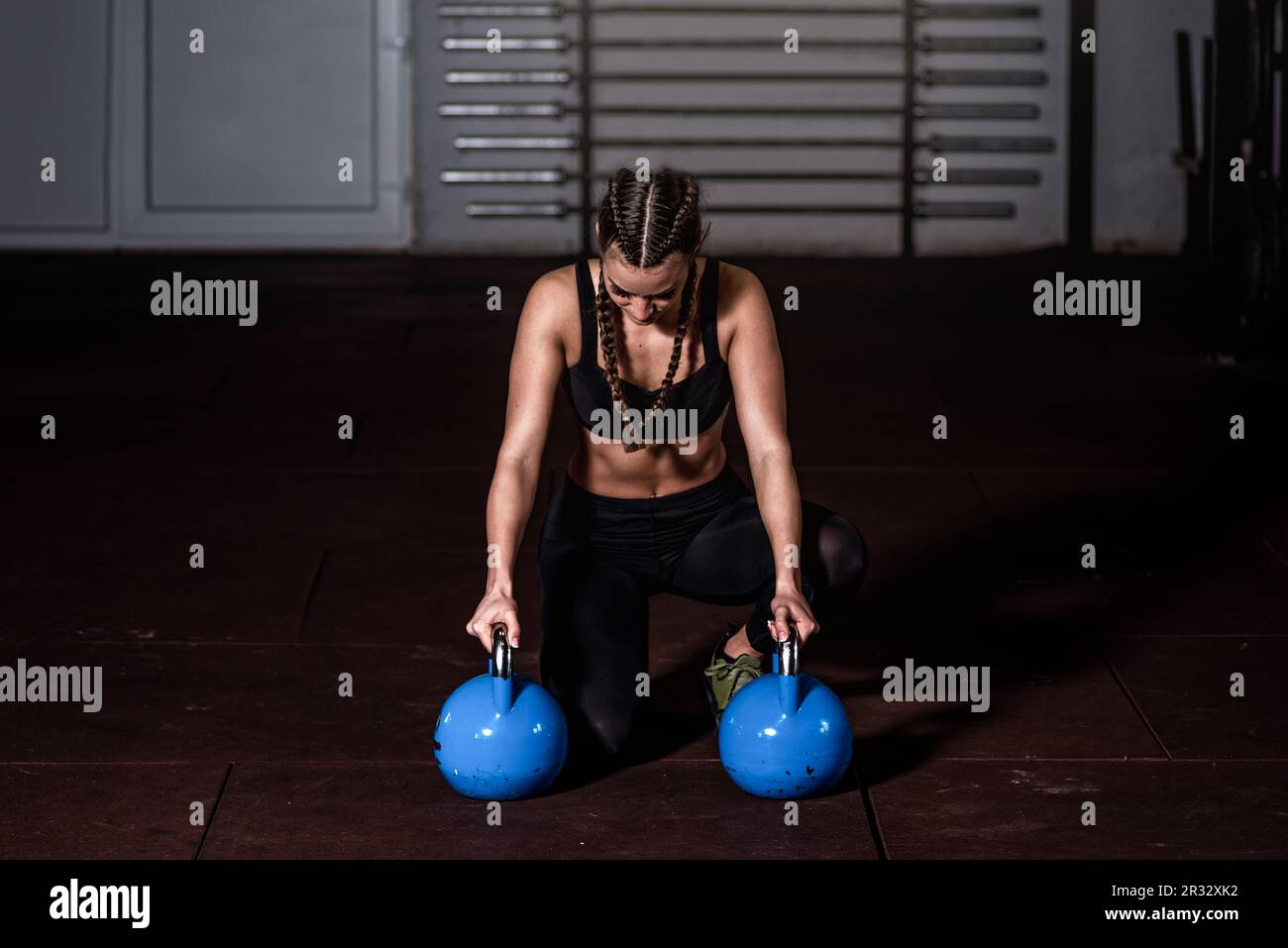 Young strong sweaty focused athlete muscular woman with muscles heavy kettlebell weight barbell dumbbell iron crossfit training hardcore workout gym Stock Photo Alamy