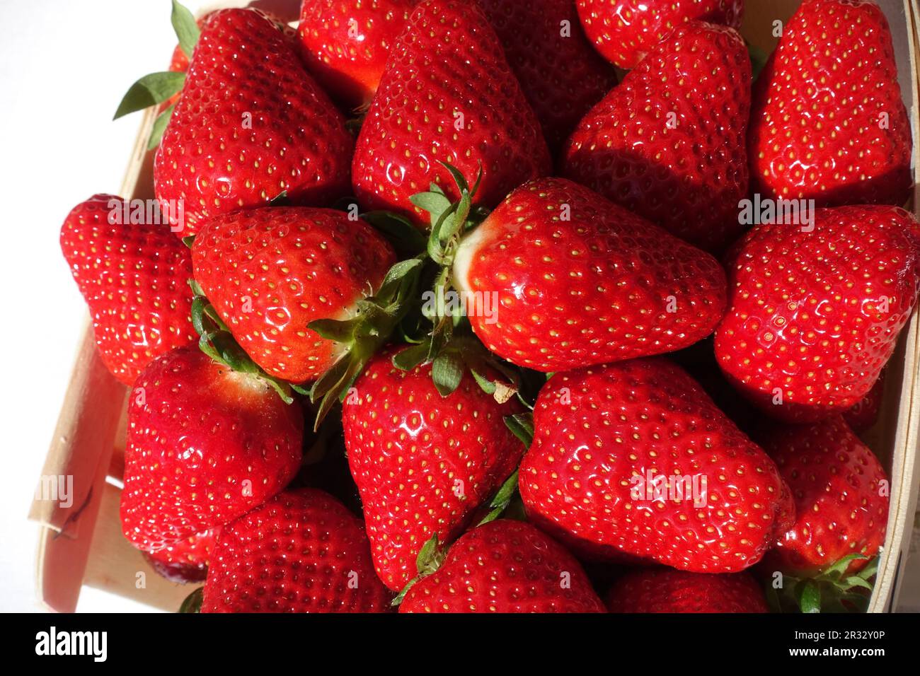 Red ripe strawberries in a basket at a farmers market in France Stock Photo