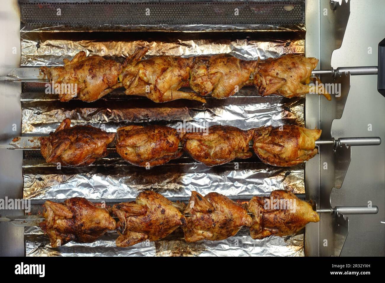 https://c8.alamy.com/comp/2R32YXH/a-stack-of-grilled-chicken-on-a-skewer-fried-in-a-commercial-oven-at-a-farmers-market-in-france-bar-b-q-heat-horizontal-inside-machine-shop-ski-2R32YXH.jpg
