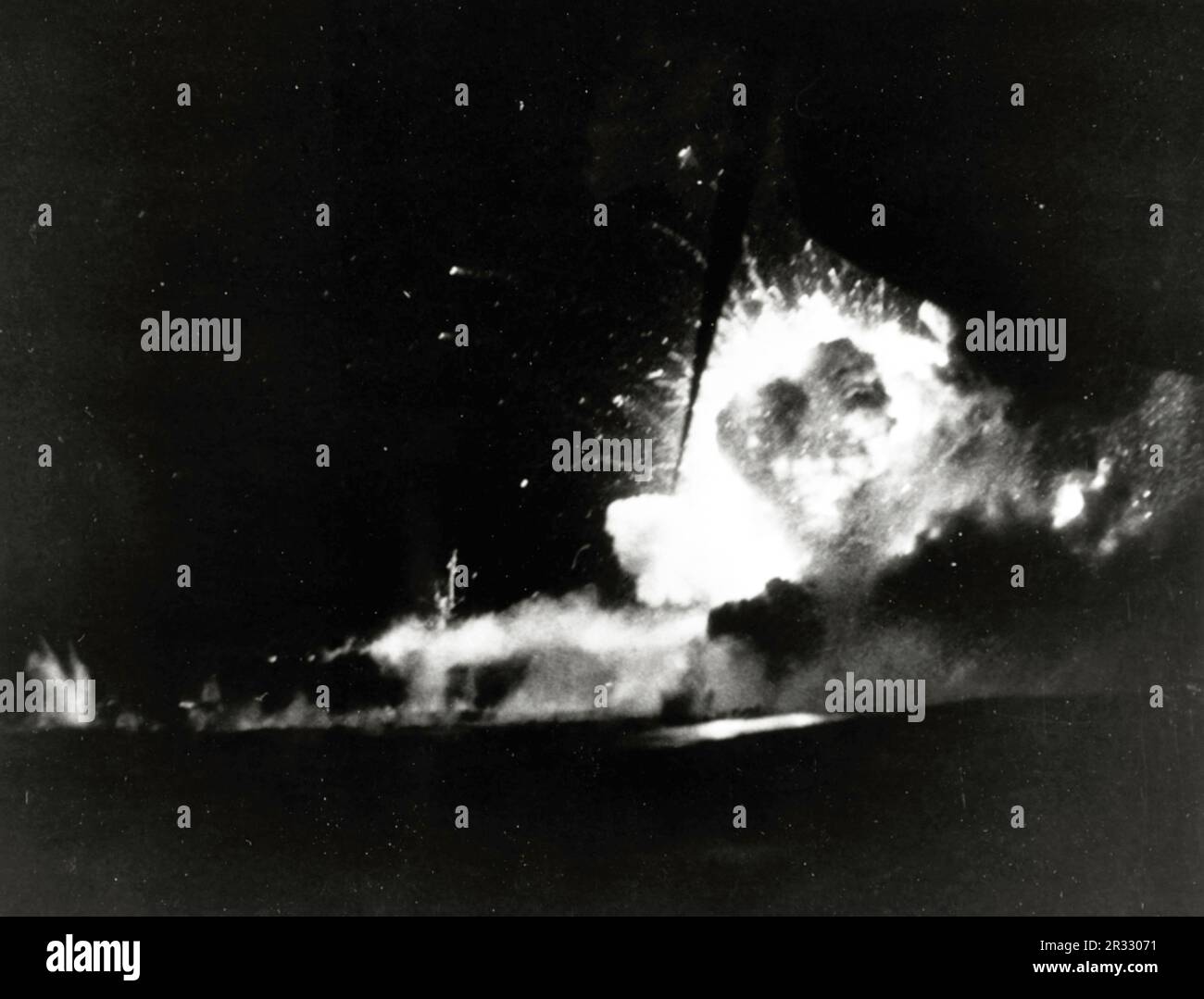 A large explosion erupts on board the escort carrier USS Bismarck Sea (CVE-95), after she was hit by a Kamikaze during the night of 21-22 February 1945, while she was taking part in the Iwo Jima operation. She sank as a result of her damage. Photographed from USS Saginaw Bay (CVE-82). When Japan was facing defeat in late 1944 it chose to destroy US ships with suicide bombings, known as Kamikaze.These attacks were a potent physical and psychological weapon and sunk a total of 47 ships at a cost of more than 3000 pilots and planes. By late 1944 the US Navy was large enough that the losses were i Stock Photo