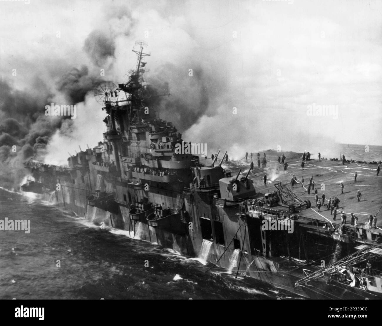 The US aircraft carrier USS Franklin stationary and on fire on 19 March 1945. The Franklin was hit by two bombs which caused major damage to the carrier.  The Franklin did not sink nd returned to the USA for repair. The ship was decommissioned in 1947 and scrapped in 1966. Stock Photo
