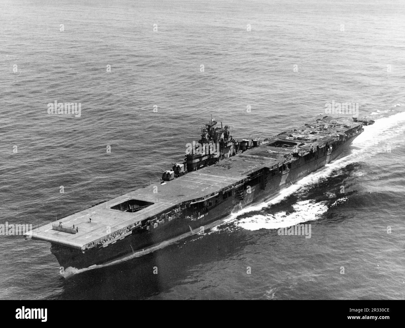 The damaged US Essex Class carrier USS Franklin (CV-13) at New York in 1945. The ship was badly damaged by two bombs on 19 March 1945.The strike caught fully fuelled and armed planes on deck and started very dangerous fires. Though heavily damaged the ship did not sink and returned to the USA for repair. The ship was decommissioned in 1947 and scrapped in 1966. In this photo the heavy damage to the flight deck and the island superstructure is clearly visible. Stock Photo